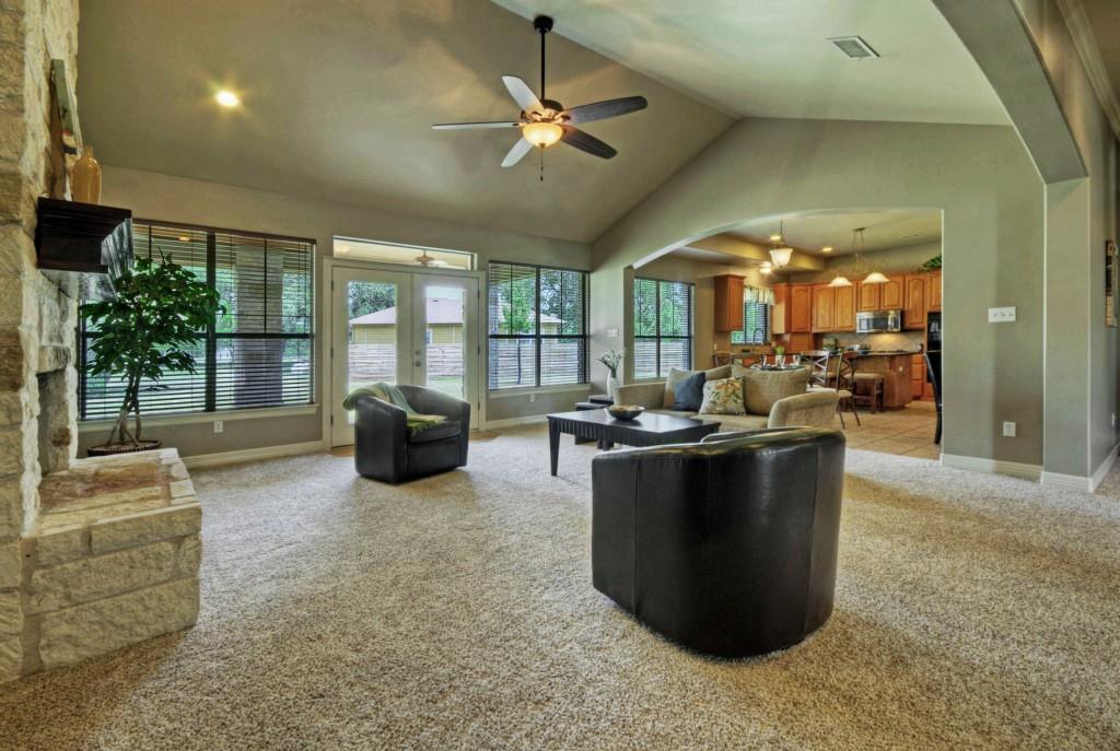 Alternate view of living area, with kitchen beyond
