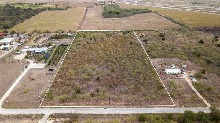 Aerial view of sparsely populated area with property boundaries highlighted