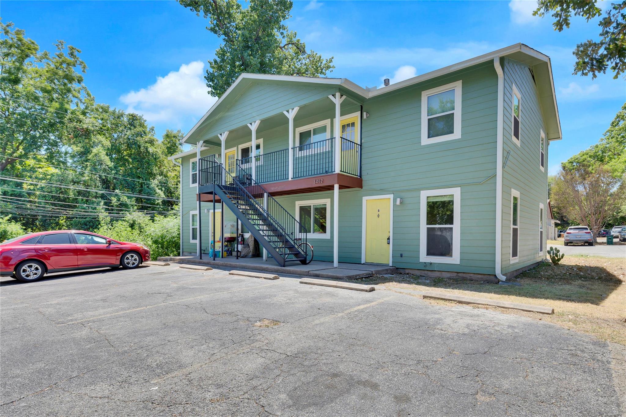 View of front of house with stairs and uncovered