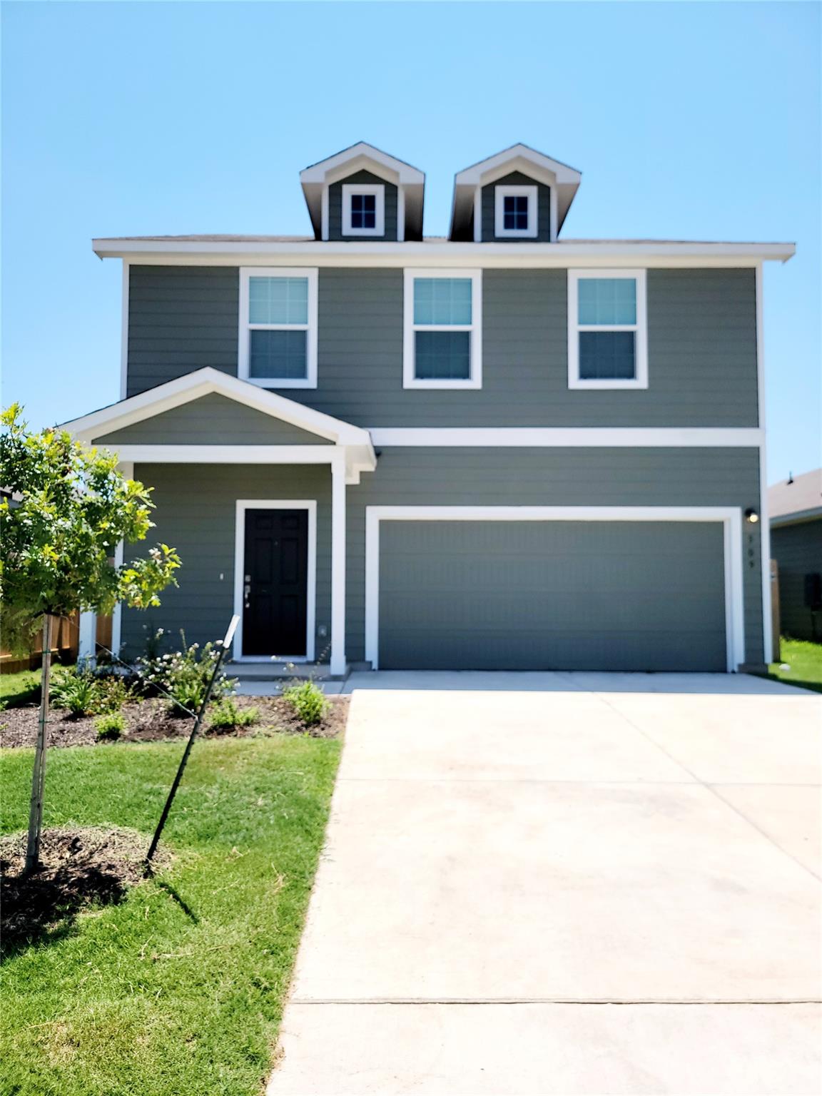 View of front of house featuring a garage, drivew