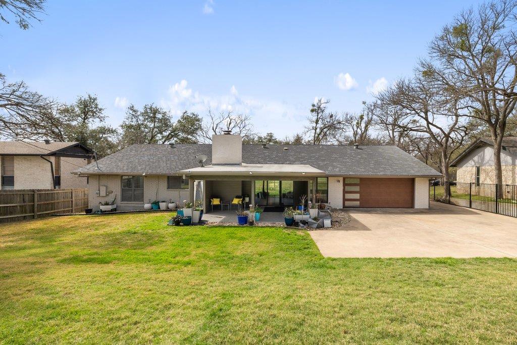 View of front of house with a front yard and bric