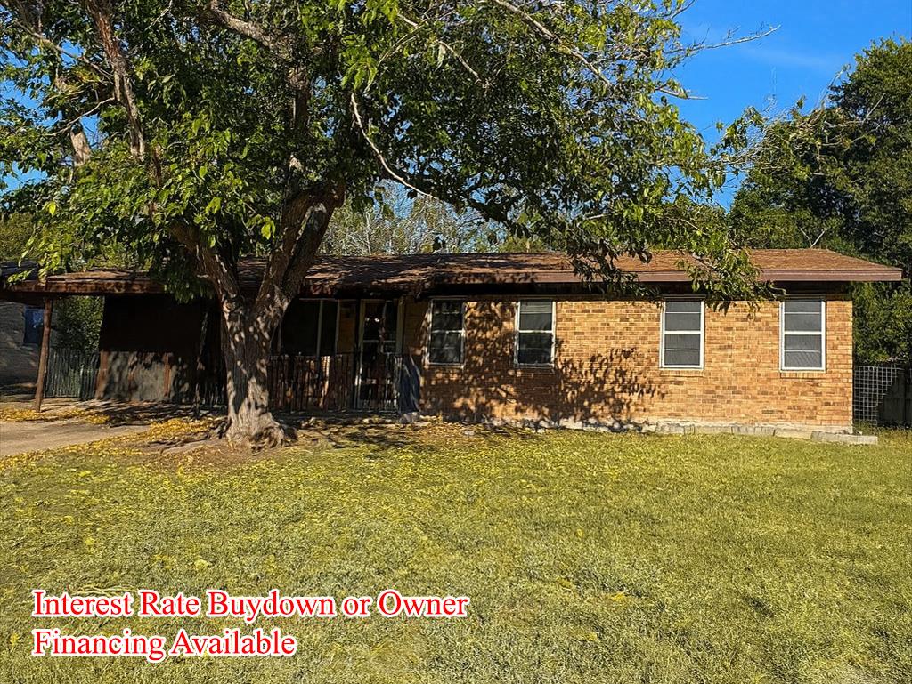 Single story home with a front lawn and brick sid