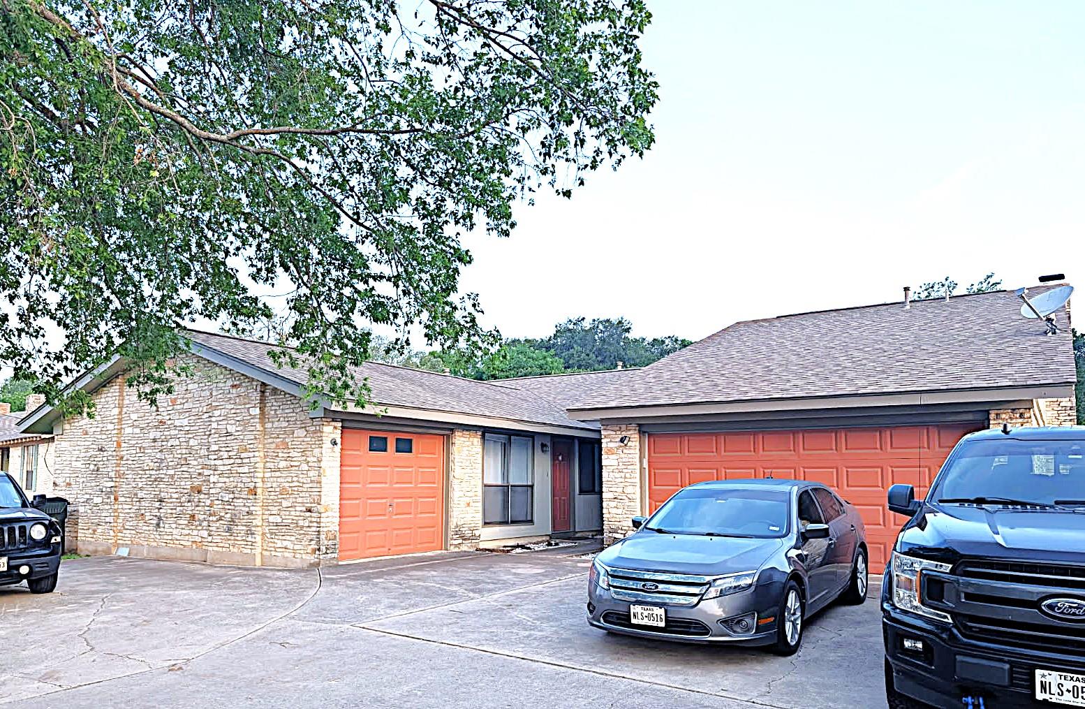 Brick veneer exterior with a concrete driveway an
