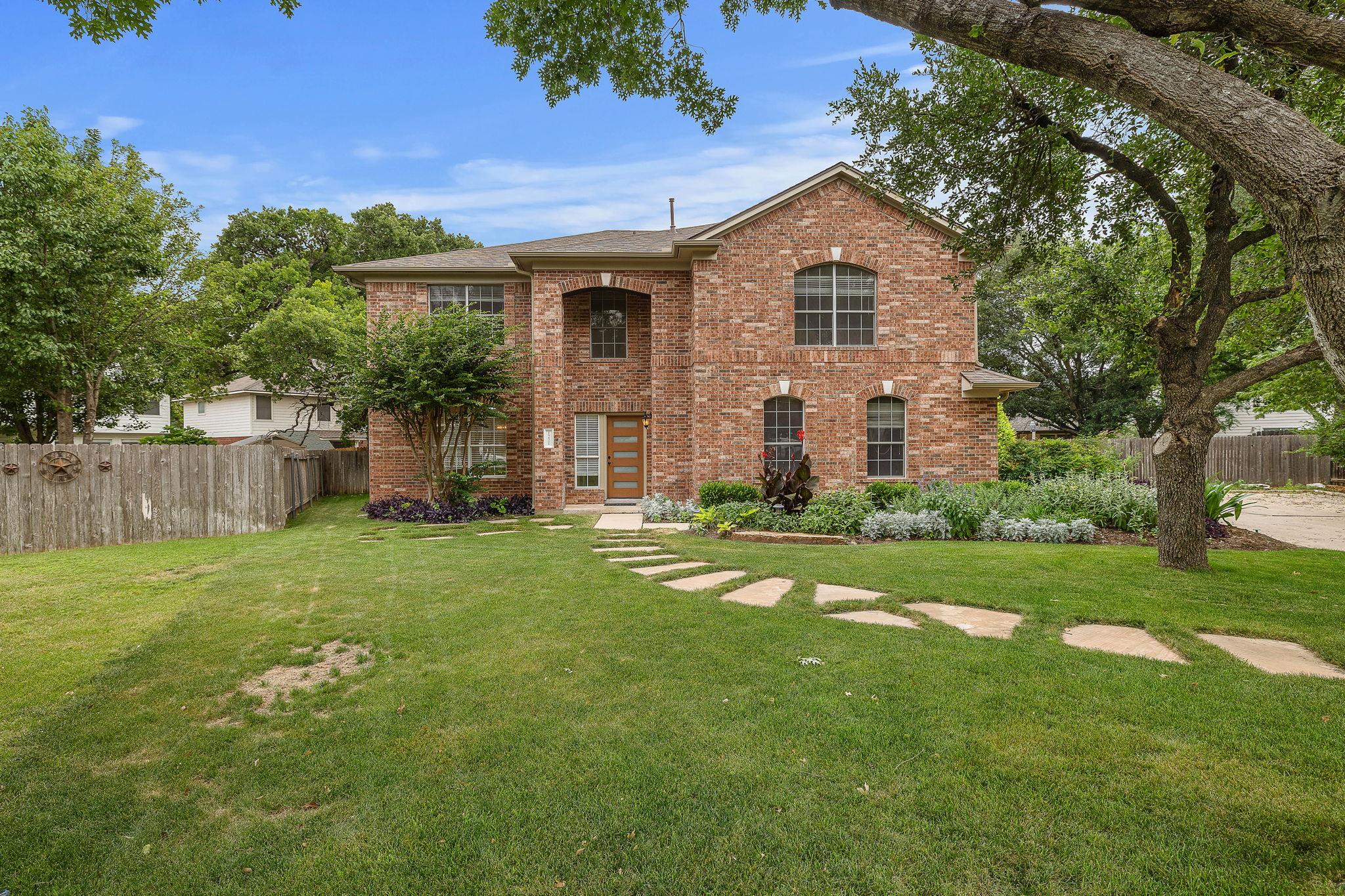 View of front of property with brick siding and a