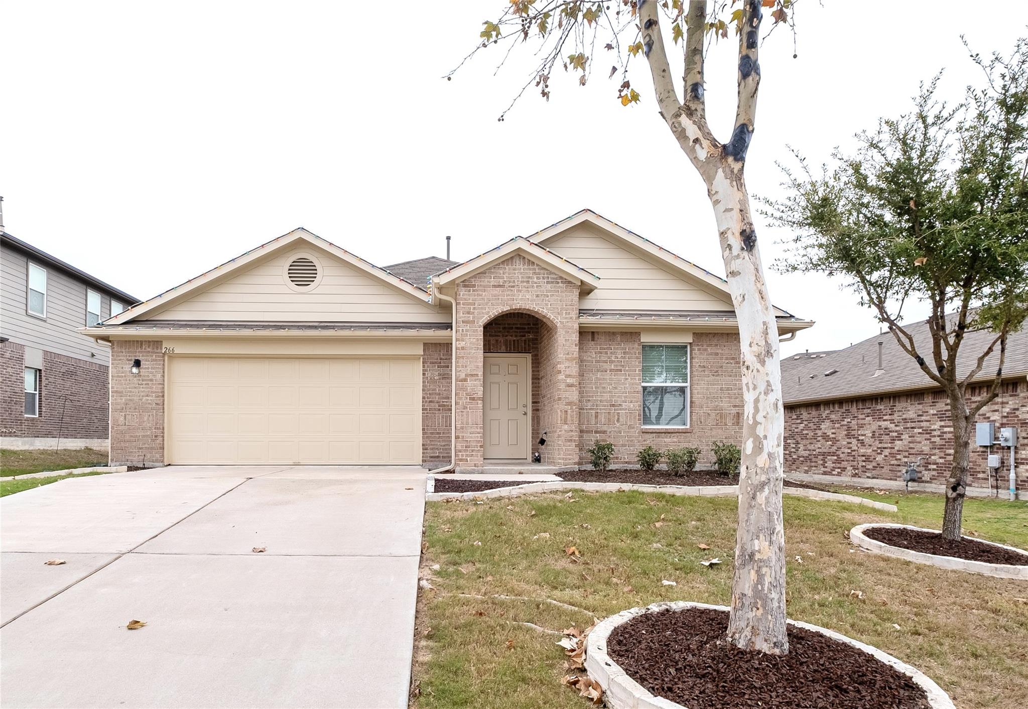 Single story home with concrete driveway, a front