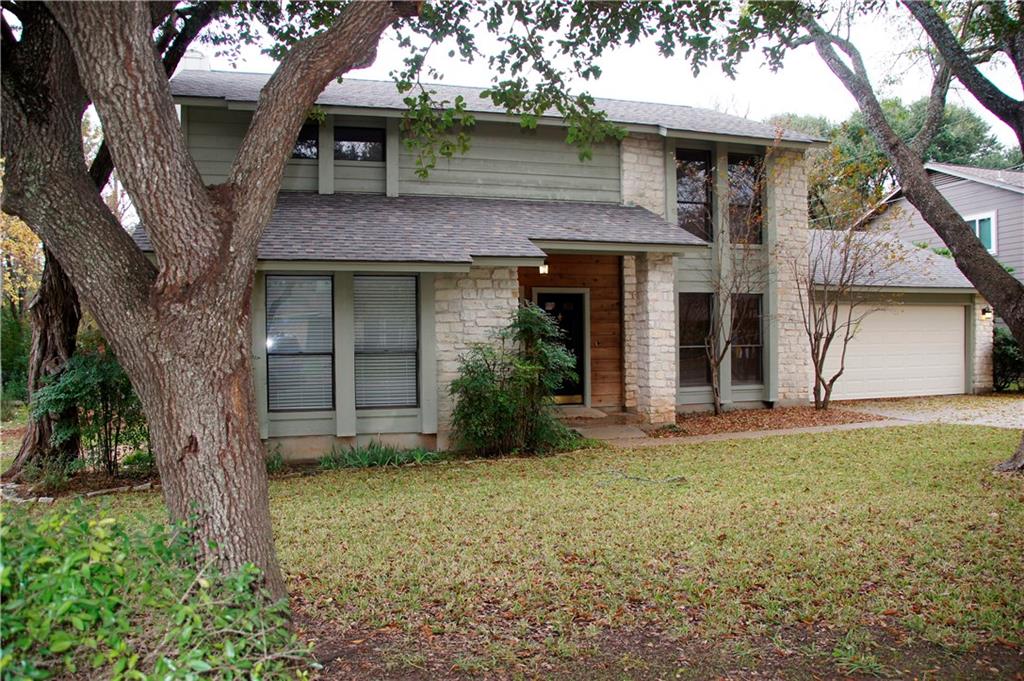 Texas limestsone front, with cedar siding in a shady front lawn!