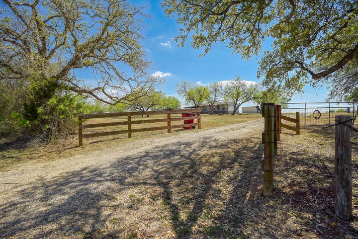 View of dirt / gravel road featuring a view of rural / pastoral area
