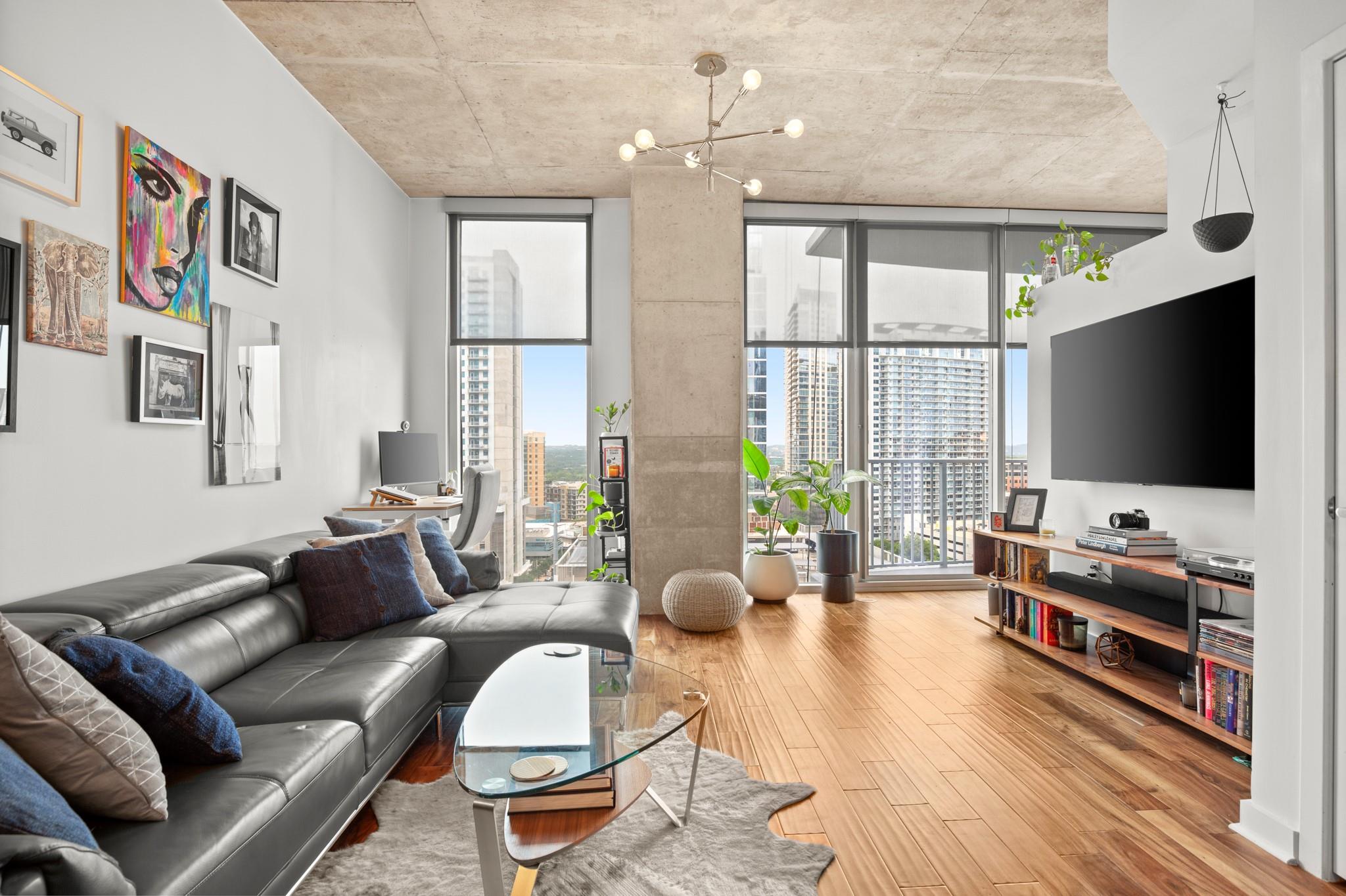 Open-concept living area with wood-finish floorin