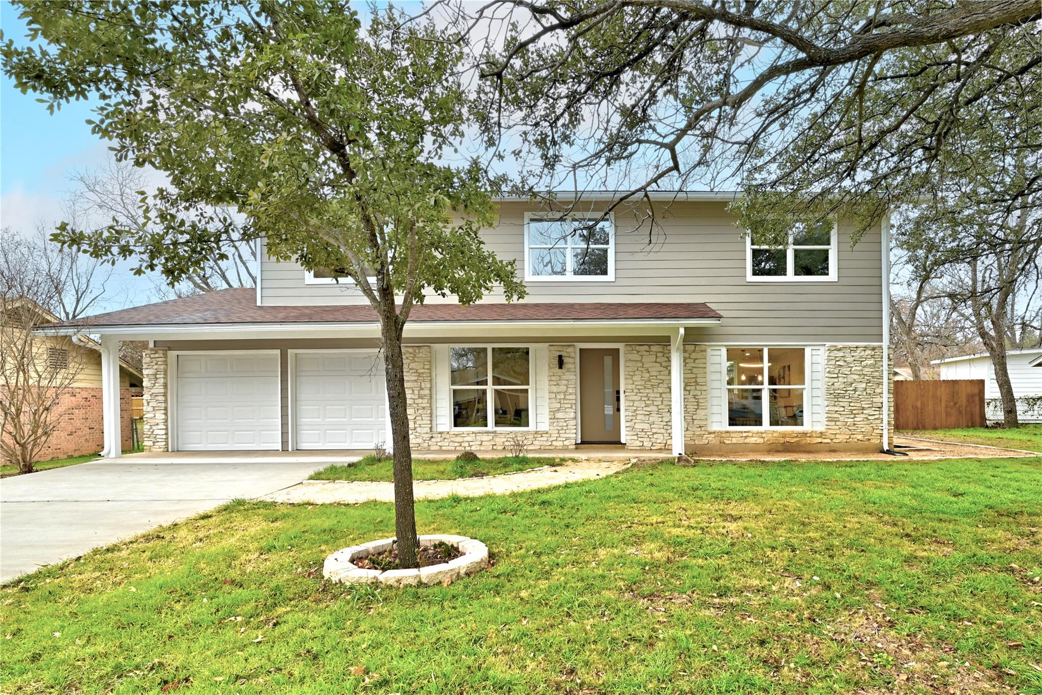 Traditional-style house featuring stone siding, d