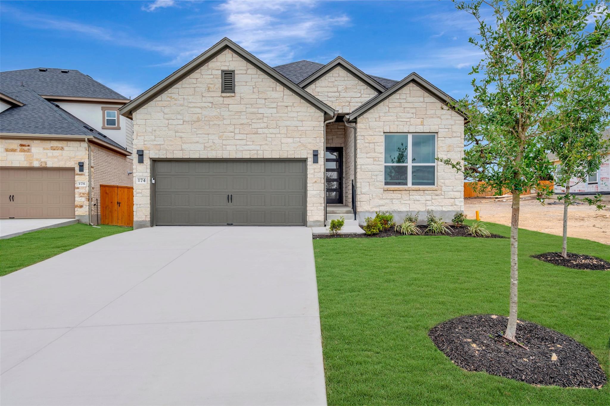 Stone facade residence featuring a two-car garage