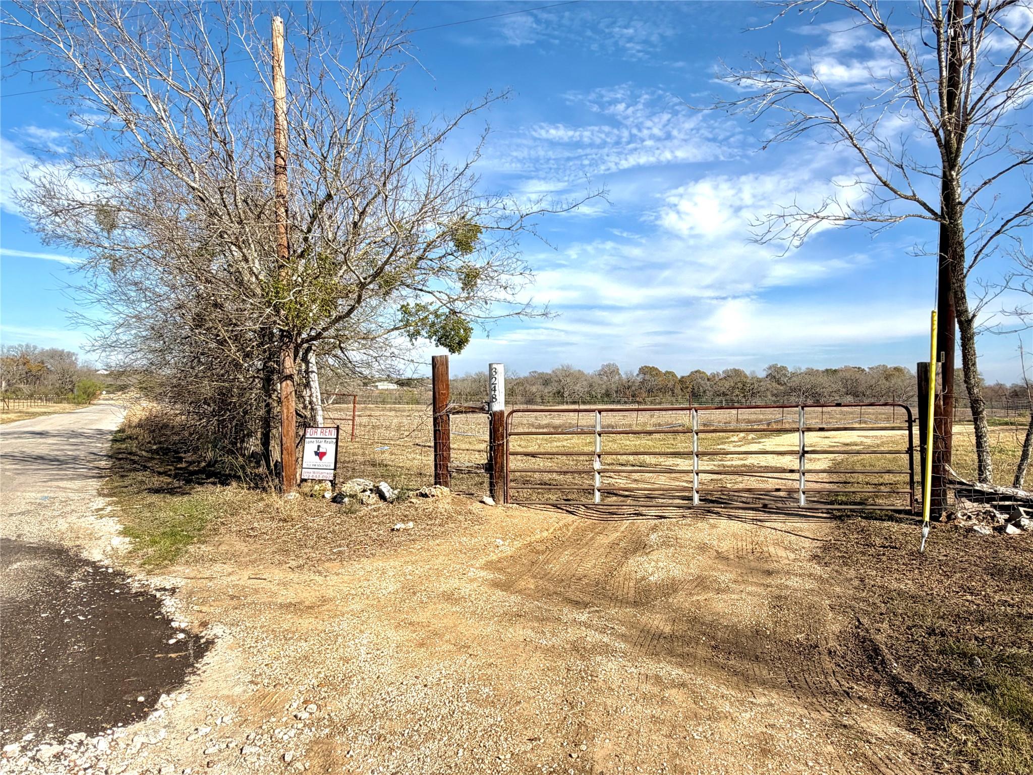 View of yard with a gate and a view of rural / pa