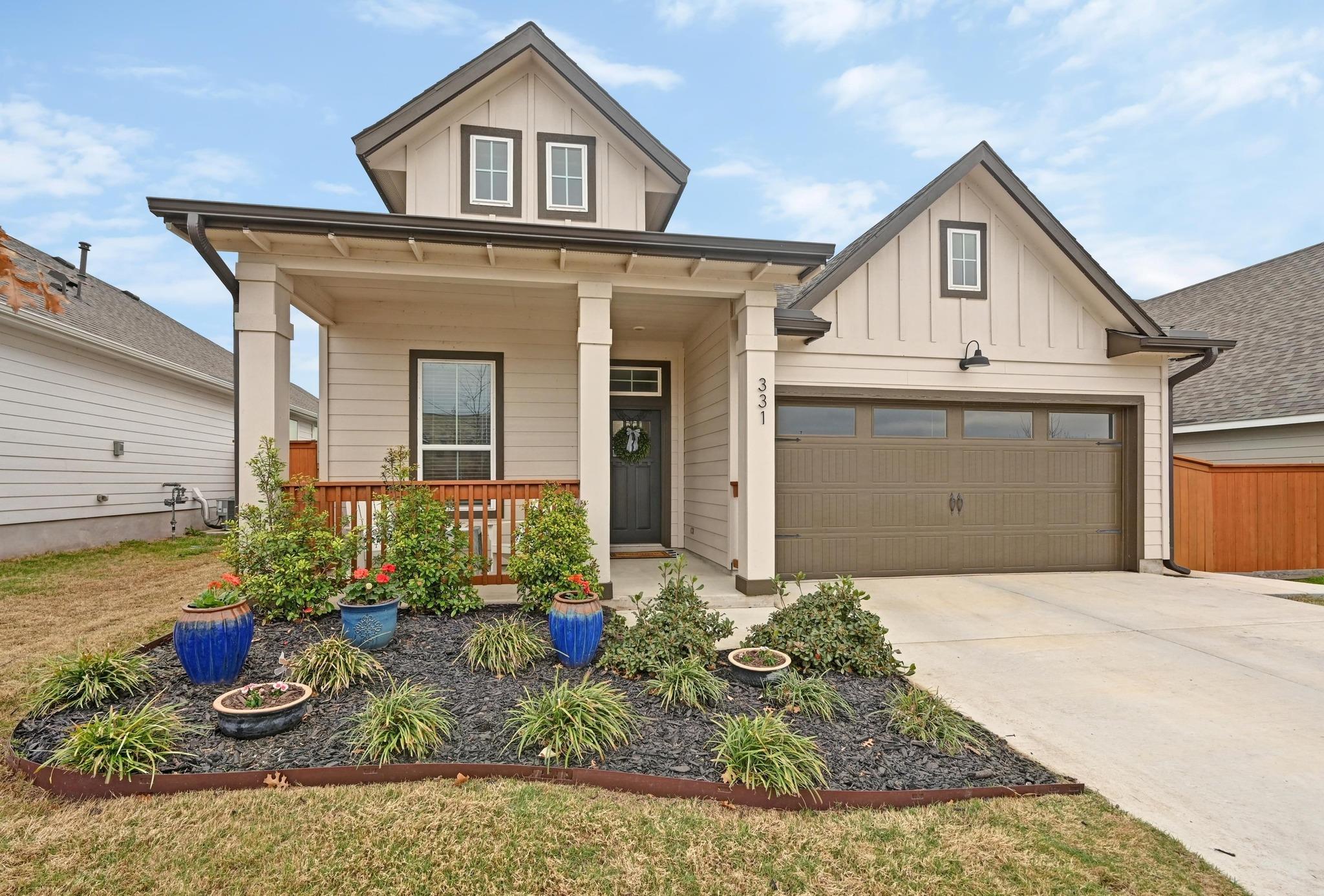 View of front of property with a porch, board and
