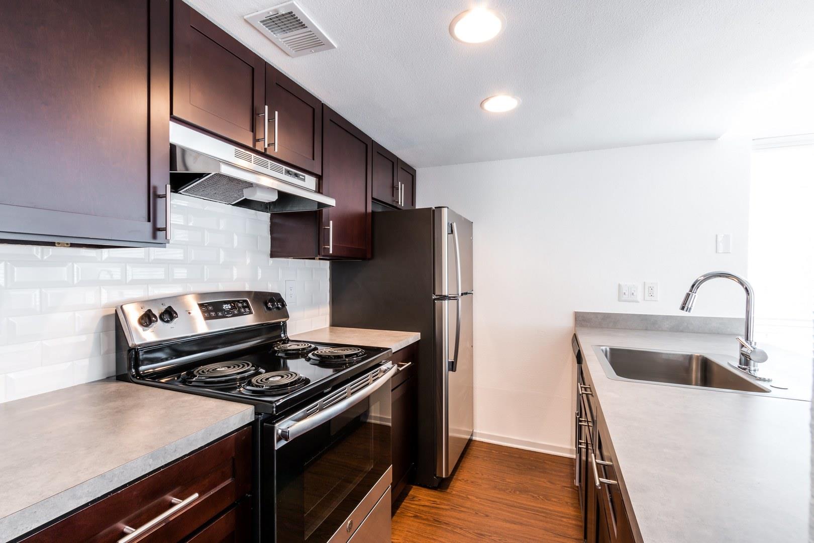 Kitchen featuring dark wood-finish cabinetry with