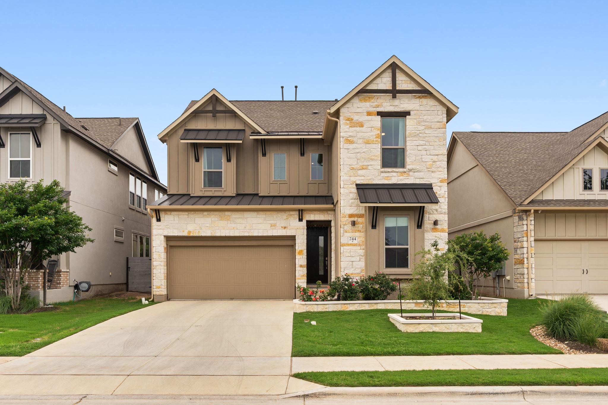 Two-story residence featuring a stone and board-a
