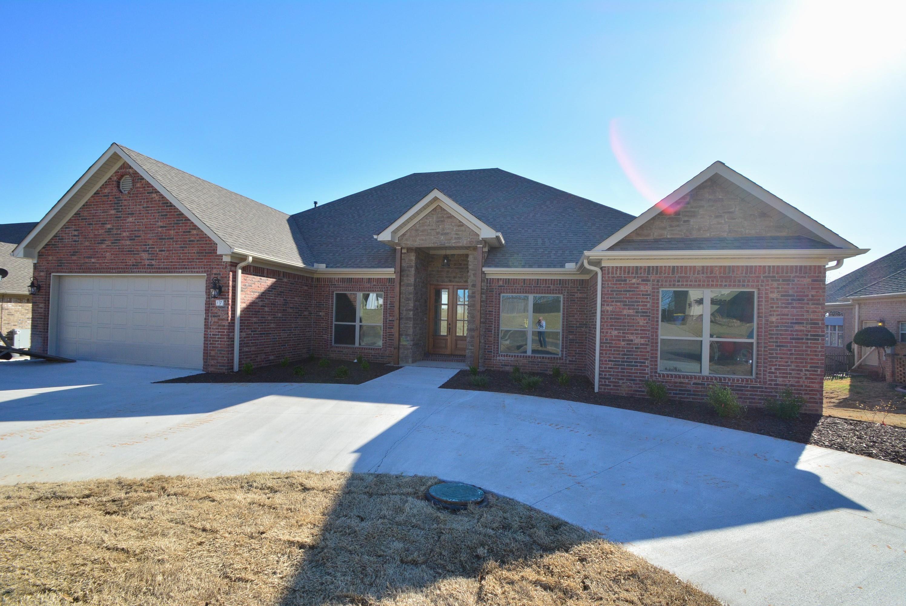 This stunning 4-bedroom, 3.5-bathroom home is nestled on the prestigious Greystone golf course. The brick exterior, accented with stone is complemented by a circular driveway leading to double 8' solid mahogany doors. Inside, the formal dining room and expansive living area feature wood-look tile flooring, with the exception of the bedrooms. The living room boasts floating shelves flanking a gas log fireplace and a wall of windows offering breathtaking golf course views. The gourmet kitchen is equipped with upgraded stainless steel appliances, including a gas cooktop and convection wall oven. A dedicated coffee bar enhances the breakfast area. The primary suite offers a soaker tub with a walk-in tile shower with a rain head, and custom cabinetry in the closet. The split-bedroom layout includes one bedroom with an en-suite bathāideal for in-law quarters or guests. Outdoors a covered back porch with a stairway to a large concrete patio and a golf cart garage beneath the house with ample parking. Sealed crawlspace with dehumidifiers, a tankless water heater, radiant barrier roof sheathing, spray foam insulation, and a 14 SEER Trane unit, contribute to low utility bills.