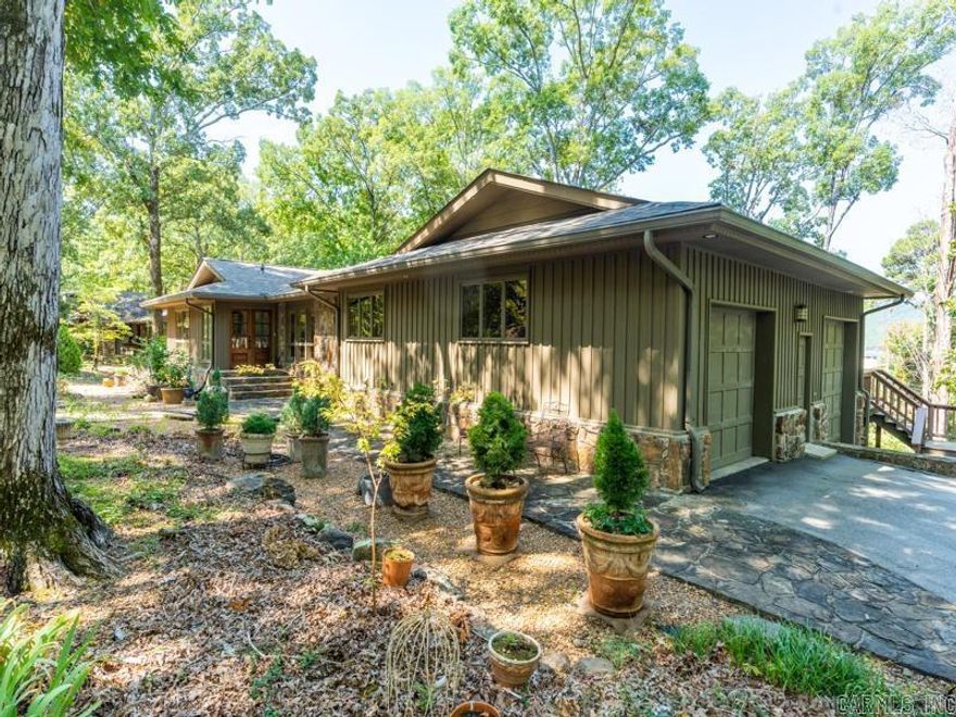 Lovely Eden Isle Home (likely designed by Frank McGary) with 4 bedrooms, 3 full baths, 2 very large living areas, updated kitchen with high-end stainless appliances and new cabinetry!  Lots of hardwood flooring, cathedral ceilings of beautifully painted tongue & groove wood, walls of glass overlooking Greers Ferry Lake and a very spacious deck!  2-car garage, updated bathrooms and numerous other improvements!  5 minute golf cart ride to Eden Isle Marina!