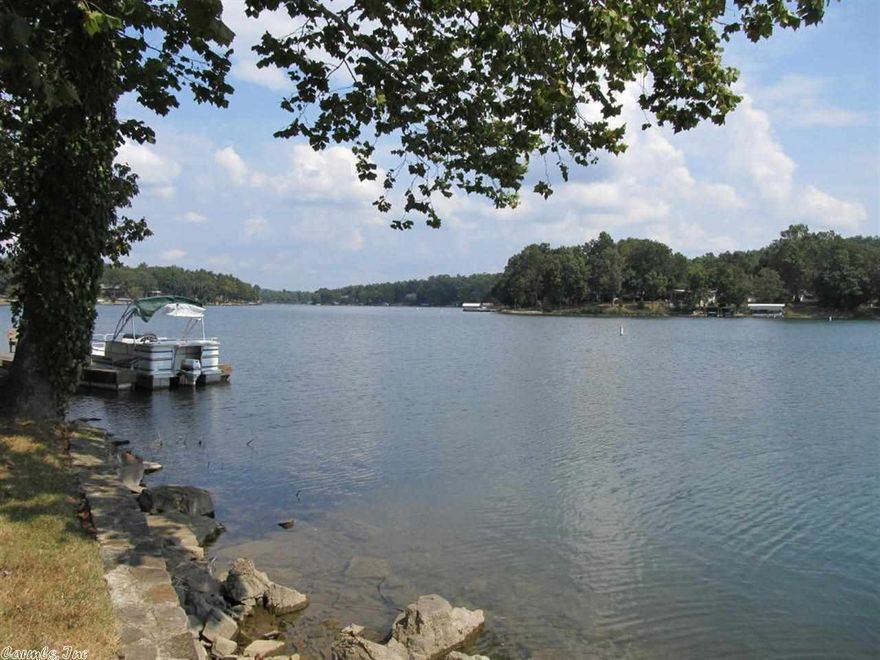 Wonderful Lake Thunderbird Home with 4 bedrooms, 3 baths, covered back deck, finished walkout basement, patio, gently sloping lot, stone seawall, U shaped boat dock and fenced backyard.