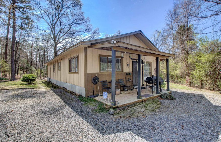 Adorable Cozy Cabin that you will fall in love with. Enjoy country living on an acre of land and having space between your neighbors. Front Porch offers a warm welcome that you will enjoy. 4 bedrooms 2 baths. 1248 SF Living Space. House sits on 0.80 Acre Land approximately. Completely remodeled and updated, plumbing and electrical. New pex water lines for plumbing and new electrical wiring, new electrical outlets and  electrical panel, new walk in shower in Primary Bathroom. French Doors in Spacious Primary Bedroom.  New remodeled kitchen and both bathrooms updated. Flooring tile in bathrooms, vinyl and LVP throughout. New Paint all over. New water heater. 4 Mini-split's heat and cooling units that you can control separately or together. New Architectural Roof, New Kitchen Appliances. Move In Ready. All Electric Utility. City Water and Septic Tank for sewer. Refrigerator, Washer and Dryer Convey with the property at Closing. Nice sized backyard. Chain Link Fence on front of property.  Less that 5 minutes to Interstate 1-40, shopping, schools, churches and restaurants.