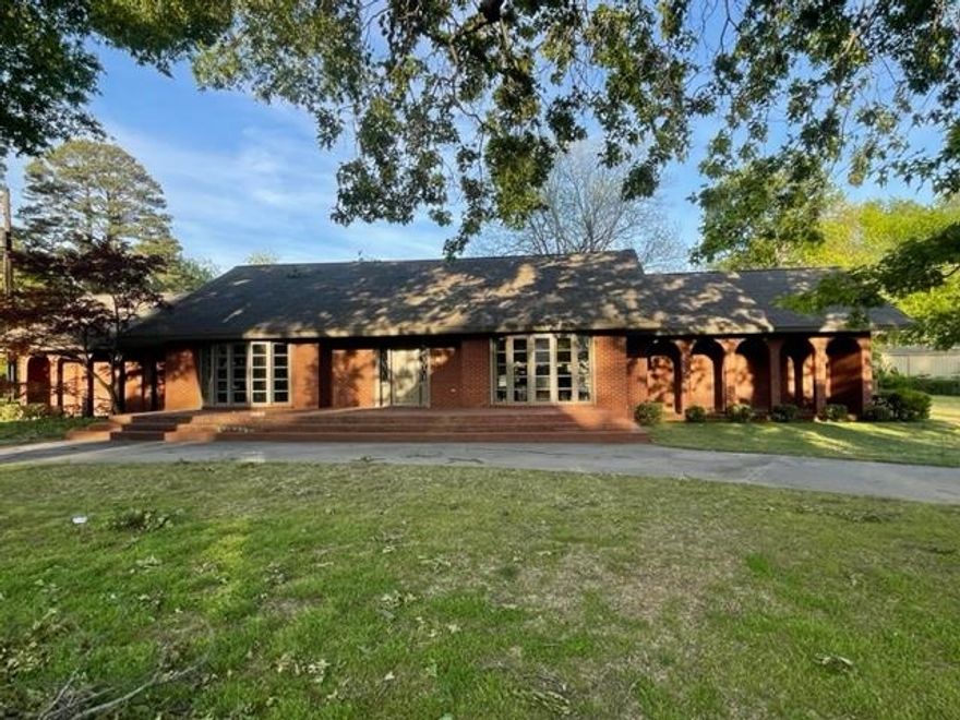 Must see, one of Carliisle's most elegant homes.  Located on an amazing corner lot with mature tress and circle drive, this home has an open floor plan with extra architectural features that enhance the beauty of the interior of the home.  There are 3 large informal living areas, one with a wood burning fireplace.  Also, a spacious dining area and additional living areas span across the entire front of the home, featuring 2 bay windows. This 3 bedroom 2 bath home has a large master bedroom. The utility room and other closets provide extra storage.  Double garage with remote garage door.