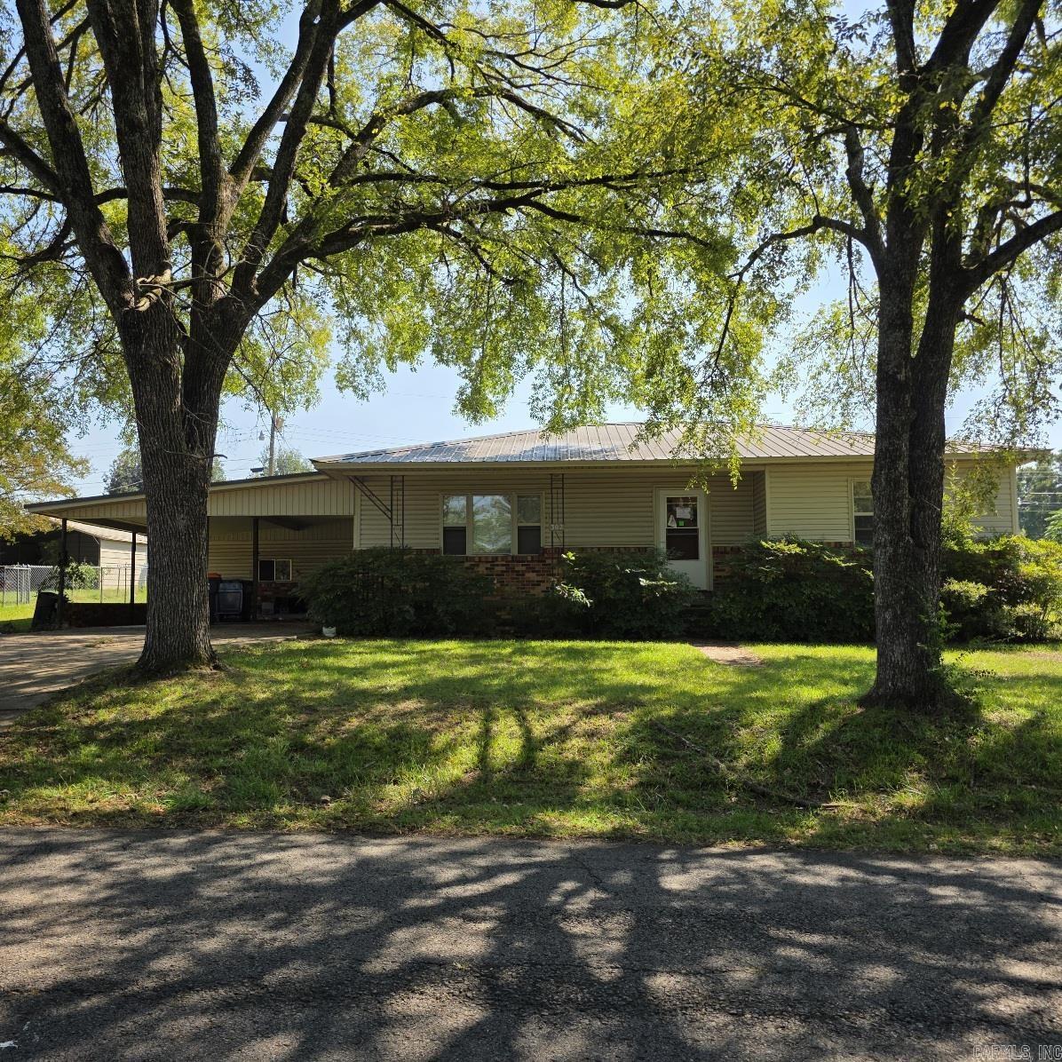 3 bedroom 1 bath home with 2 car attached carport plus a 2 car detached carport. Half acre corner lot offers room for gardening and other outdoor activities. It has a lean to behind attached garage and an outbuilding for storage and hobbies. It has a shaded front porch and front yard. The home has vinyl siding, metal roof, packaged HVAC unit, and newer vinyl windows. All offers to be submitted via Res.net by buyer's agent. Offers will be entertained after property has been exposed on the MLS for 7 calendar days. Agents read Agent Remarks