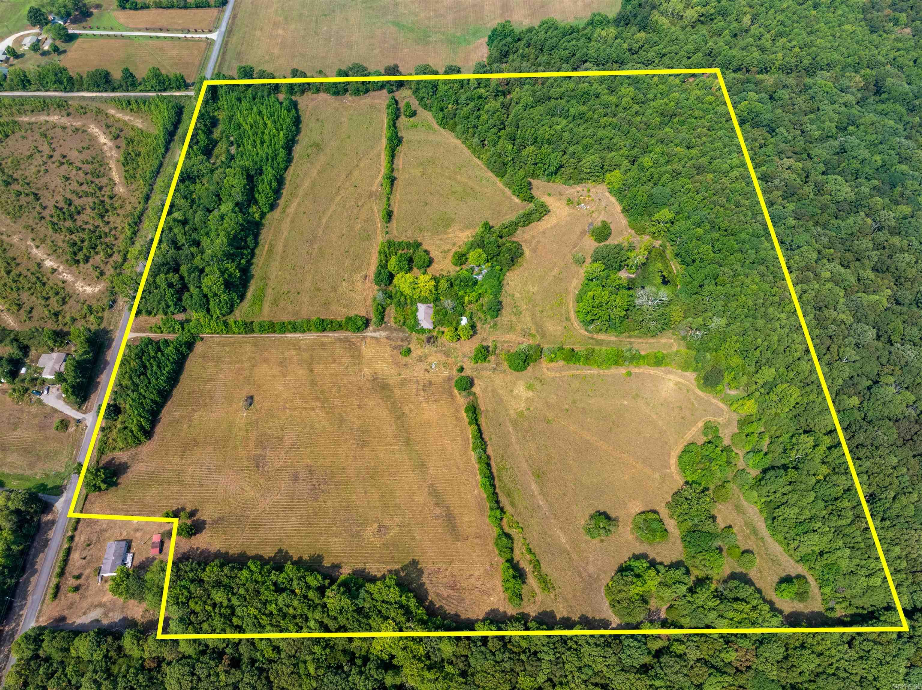 38 +/- Acres with Pond, Pasture, Woods & Old Homeplace ā Quitman, Arkansas What an incredible piece of property just outside of Quitman, Arkansas! This 38 +/- acre tract in Cleburne County offers a beautiful mix of open hay fields, fenced pasture ground, mature woods, and a pondāmaking it an excellent choice for farming, hunting, or building your dream home. A private driveway runs through the center of the property and leads to an old homeplace. The existing structure is still standing but in poor condition and not safe to enter. It would need to be removed to make way for a new build, and this homesite offers a gorgeous setting for anyone wanting to create a country retreat. The property features mature timber, fenced and cross-fenced sections, and plenty of room for cattle, horses, or other livestock. With open ground for hay production and wooded acreage for hunting, itās a rare find that combines both recreation and income potential. Located on Firehouse Road, a paved road with easy access, the land provides convenience while maintaining privacy and seclusion. Property taxes are currently just $87 per year, making it an affordable long-term investment.