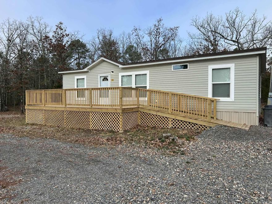 Charming 3 Bedroom, 2 Bath Home on 2 Acres — Discover comfort, privacy, and convenience with this well-maintained double-wide mobile home situated on a beautiful 2-acre partially wooded lot. Whether you’re looking for a rental investment, a vacation getaway, or a forever home, this property offers versatility and value. A circle driveway welcomes you home, providing easy access and ample parking. Enjoy the reliability of city water, and plenty of room to roam, garden, or simply relax in your peaceful outdoor space. Enjoy the beautiful front deck as you take in the fresh air and a hot cup of coffee. Located just minutes from all that Mena has to offer, including shopping, dining, and essential services. Outdoor enthusiasts will love the close proximity to the Rich Mountain trail system, with trail access only minutes away