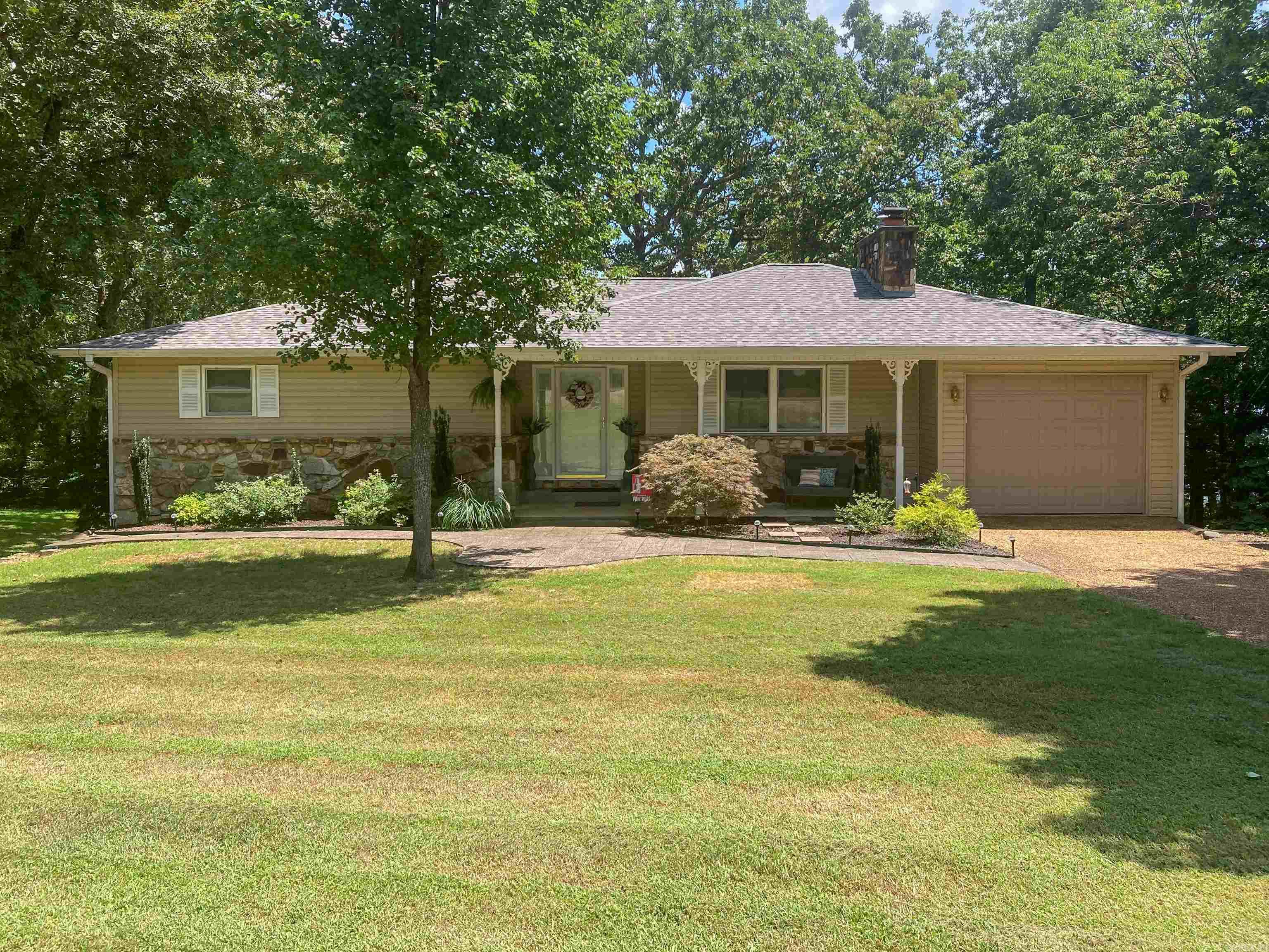 SERENE LAKE LIVING! Enjoy your morning coffee from the 544 sq. ft. expanded deck overlooking beautiful DIAMOND LAKE in Horseshoe Bend Arkansas. This spacious well-built home offers 2258 square feet of relaxation, peace and tranquility. The house boasts Anderson sliding doors (4) and Hurd custom insulated windows. Lots of built-ins throughout the home. 3/Bedrooms with 2/Full Baths and 1- ½ Bath. Walkout basement area offers multifunctional spaces such as: Large Bedroom/ Family Game Room/ Office/Workshop/Additional Sleeping Area and lots of storage. New roof installed July 2025! Outside 12X10 storage building is perfect for all your fishing and lake accessories. Private lake access from your own boat dock! Book your appointment for a private viewing today!