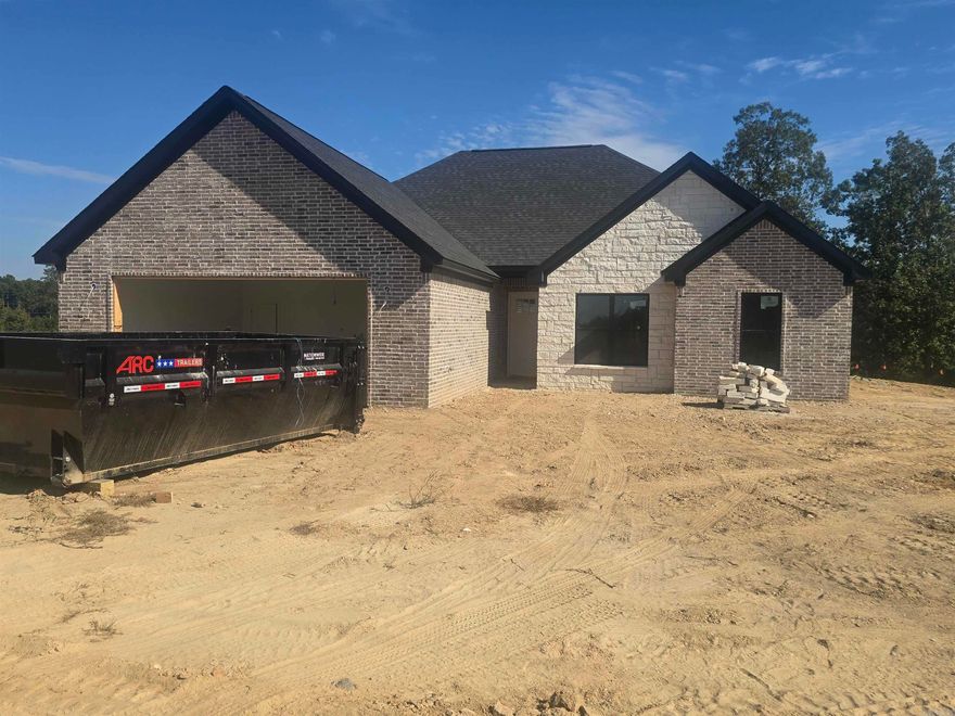 Welcome to 4000 Creek Top in the beautiful Plantation Hills subdivision! This inviting 2,000 sq ft home sits on a peaceful 1+ acre lot in the sought-after Bauxite School District. Perfect for a growing family, this home combines space, style, and thoughtful design with 4 bedrooms, 2.5 bathrooms, and an open floor plan that blends comfort and functionality. The living room features a wood-burning fireplace with a convenient gas starter, making it easy to light and enjoy a cozy night with the family. Inside, you'll love the beautiful luxury vinyl floors throughout, a stylish backsplash that compliments the quartz countertops, and an oversized pantry for extra storage. The foam insulation provides energy efficiency, and the upgraded hardware throughout adds a refined touch. The primary suite includes a tiled walk-in shower and a freestanding tub, while the guest bathroom features a tiled shower/ tub surround for a more cohesive, high-end finish. Outside the brick and stone exterior offers timeless curb appeal and a peaceful setting! I promise you don't want to miss this one. Schedule a showing today! Estimated completion Nov. 2025. Professional pictures coming soon.