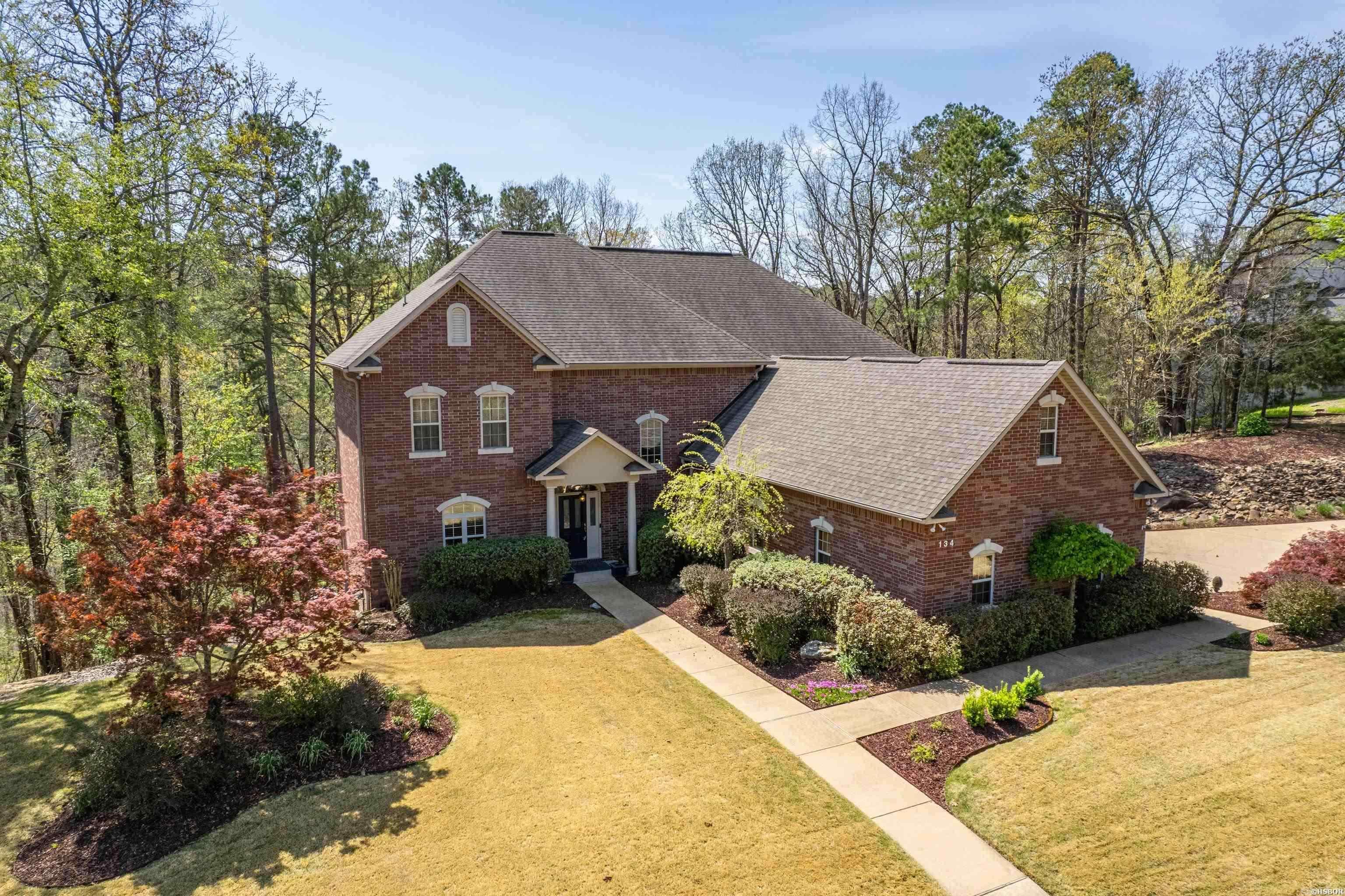 Welcome to this stunning 4 bedroom,3.5 bathroom home located on a quiet cul-de-sac in an upscale neighborhood.This upscale property offers privacy and tranquility. Step inside and be greeted by the grandeur of the 22-ft ceilings and huge windows bringing in the light from outside, creating a sense of space & luxury. The separate dining room is perfect for hosting formal dinners or entertaining guests. It is located in between the living room & hearth room. It features a private deck through the french doors giving view to a private wooded back yard. The cozy hearth room and kitchen share a space, making entertaining fun and easy. There is a breakfast nook for enjoying your coffee in the morning and a pantry for your organizing needs.The main level also features a large utility room, half bathroom & large storage room in the hall. Enjoy relaxing evenings in the spacious master suite with a luxurious en-suite bathroom featuring a soaking tub and shower. There are three additional bedrooms and two bathrooms upstairs. In addition there in a large family/game room, and a bonus room currently being used as an exercise area. This home offers plenty of room for family or guests. Cont'd...