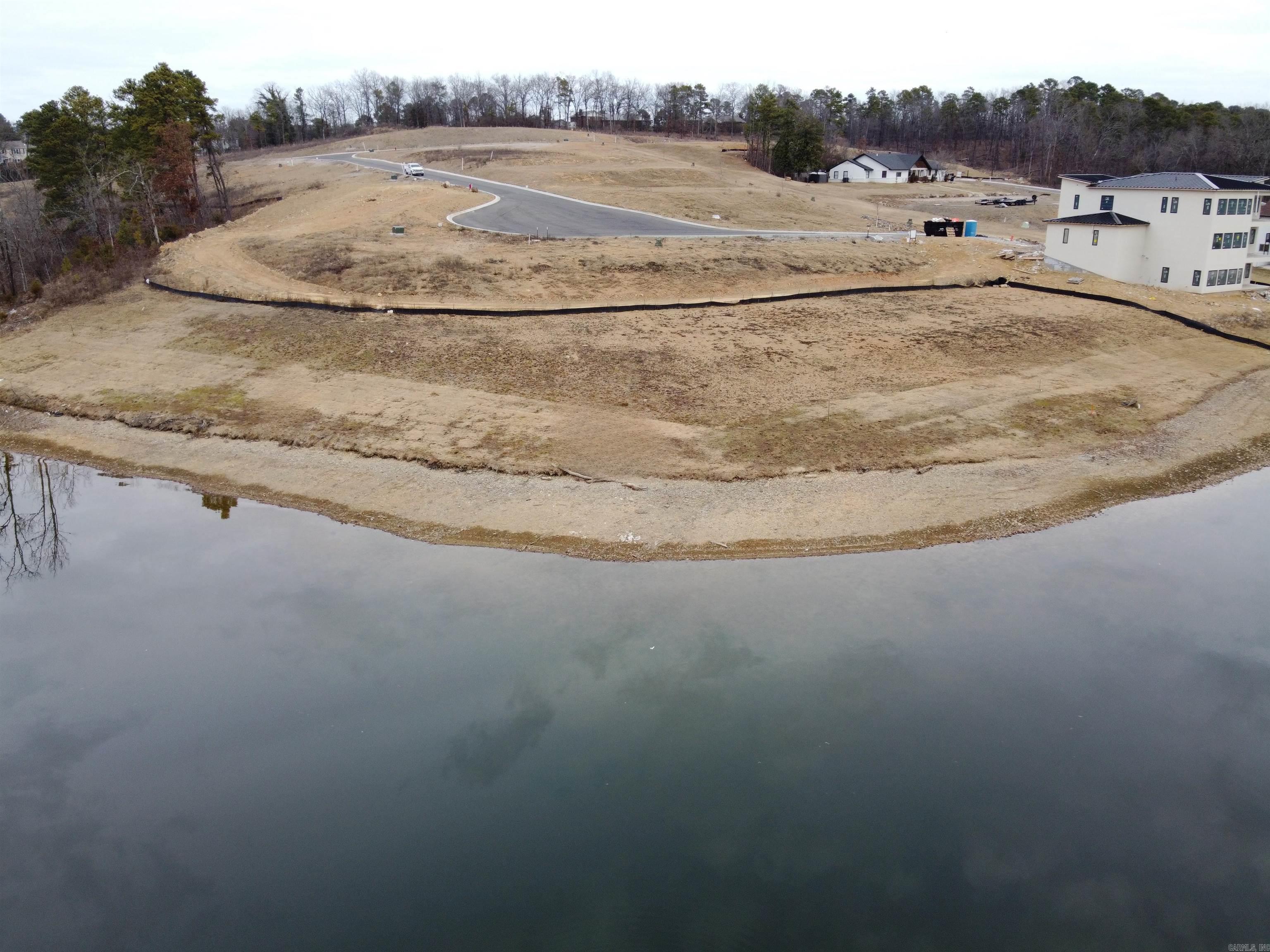 PRIME LAKE HAMILTON LOT with Stunning Views & Ideal Location! Discover the perfect opportunity to build your dream home on this magnificent Lake Hamilton lot! Boasting breathtaking panoramic water views, this premium buildable lot offers the perfect canvas for your lakefront retreat. Centrally located in the heart of Hot Springs, this property provides easy access to all the cityās top amenitiesāshopping, dining, entertainment, and the renowned Hot Springs National Parkāwhile still offering the peaceful, scenic beauty of lakeside living. Whether you're looking for a weekend getaway or a full-time lakefront home, this lot is an exceptional find. Don't miss the chance to own a slice of paradise on Lake Hamilton! Prime Location | Build-Ready | Stunning Views