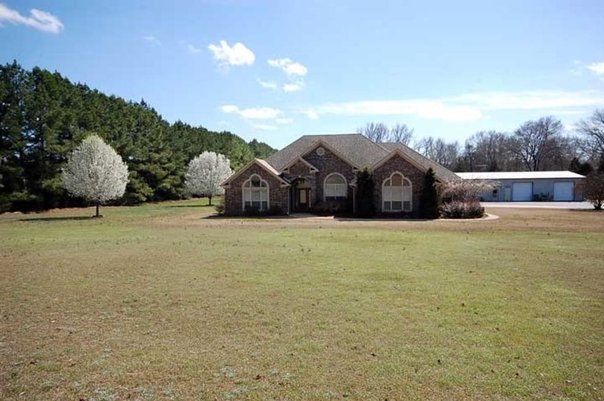 CUSTOM BUILT COUNTRY ESTATE SITTING ON 5 ACRES WITH A SHOP AND APARTMENT!! GREAT FLOOR PLAN FEATURES GREAT-ROOM WITH TWO SIDED FIREPLACE. FAMILY ROOM, FORMAL DINING ROOM, TRIPLE COLUMNS, SUN ROOM, AND SAFE ROOM! THE SHOP IS 20X60 AND IS INSULATED.THE APARTMENT IS 800 SF AND RENTS FOR $600 MONTH. BARN AND CROSS FENCED.MORGAN BLD. DOES NOT CONVEY.