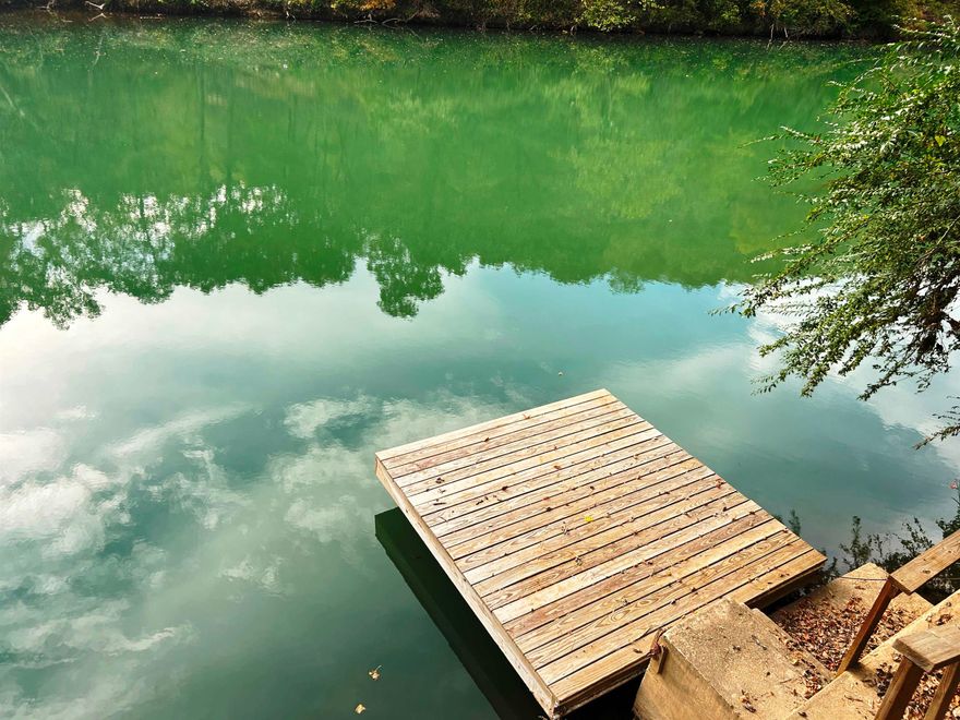 Waterfront Getaway on the Beautiful Spring River!  This riverfront lot sits on one of the best stretches of the Spring River, offering the perfect spot for relaxation and outdoor fun. The property includes a covered area with a bunkhouse and a camper that conveys, giving you a great setup for weekend getaways or summer vacations.  Step out onto your private dock for fishing, swimming, or simply enjoying the view. Located in a gated community with fantastic amenities—inground pool, picnic area, playground, and boat launch—this spot offers both comfort and adventure.  All this is just minutes from historic Hardy, Arkansas. Come enjoy the peace, beauty, and relaxation of life on the river!