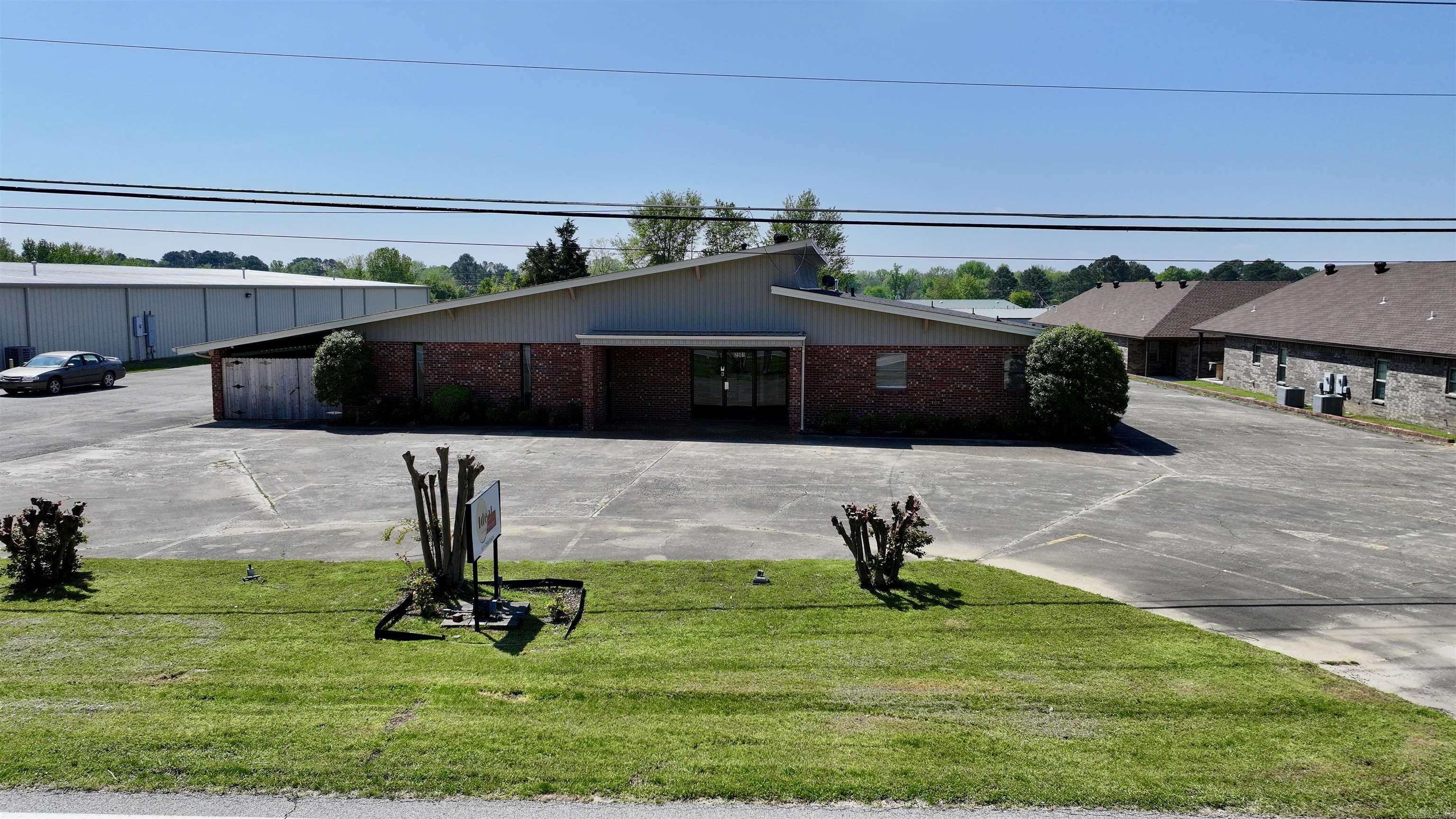 This fully renovated commercial property is perfectly suited for multiple uses including professional offices, daycare facilities, churches, or medical practices. Completed in 2023/2024, the extensive remodel features new interior paint, flooring, and upgraded lighting throughout. The layout includes several private offices, three spacious open areas, a kitchen, laundry facilities, and six restrooms, making it ideal for a wide range of organizational needs. The exterior offers ample parking, an outdoor storage/shop space, and a fully fenced area complemented by a large 14'x70' covered patio—perfect for outdoor gatherings or activities. Strategically situated in Searcy, Arkansas, at the heart of White County, this location ensures convenient access to essential retail hubs such as Walmart and Lowe's. The vibrant city of Searcy provides residents and employees alike with diverse dining, shopping, and entertainment options, anchored by the community presence of Harding University. Additionally, the property is served by excellent school districts, including Searcy Public Schools, Riverview Schools, and Harding Academy.