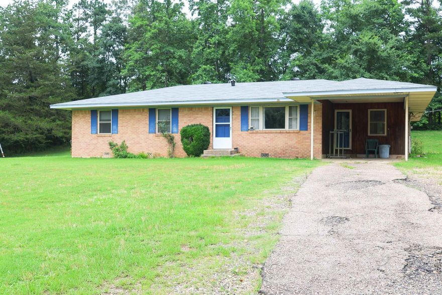 Discover comfort and space in this 4-bedroom, 2-bath brick home, perfectly situated on approximately 5 acres of land. Featuring a flexible bonus room ideal for a home office or cozy den, this home offers a layout designed for both privacy and functionality. The split floor plan provides a private primary suite, while three additional guest bedrooms share a second full bath. Inside, you’ll find thoughtful built-ins and ample storage. The spacious kitchen, dining and living area offer plenty of room for gatherings and everyday living. Outside, enjoy the convenience of a one-car carport, plus a shed and separate storage building—perfect for hobbies, tools, or additional storage needs. Whether you're looking for room to grow, space to work from home, or a country retreat, this property has it all. Schedule your private showing today!
