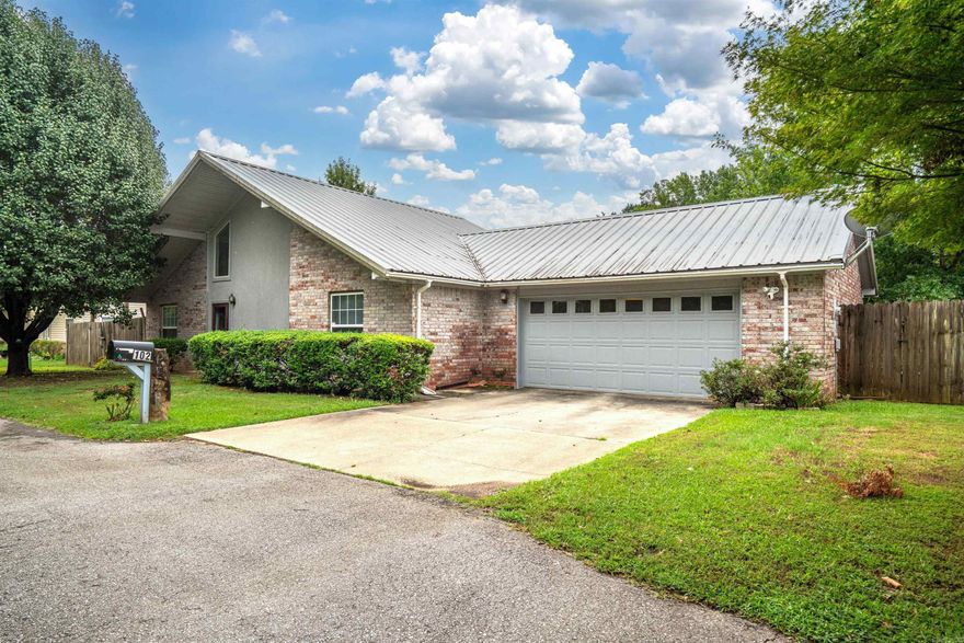 Lakefront 3 bed/2 bath with loft to serve as extra sleeping, office, or playroom.  Home has been well maintained and ready for your special touches.  Low maintenance exterior and lawn with short, flat distance to water's edge.  Craftroom/workshop with A/C source in garage or remove for extra parking.  Metal roof and covered patio to enjoy the lakeside under shade. Plenty of frontage to add dock. County location perfect for short-term rental program with no permits required.