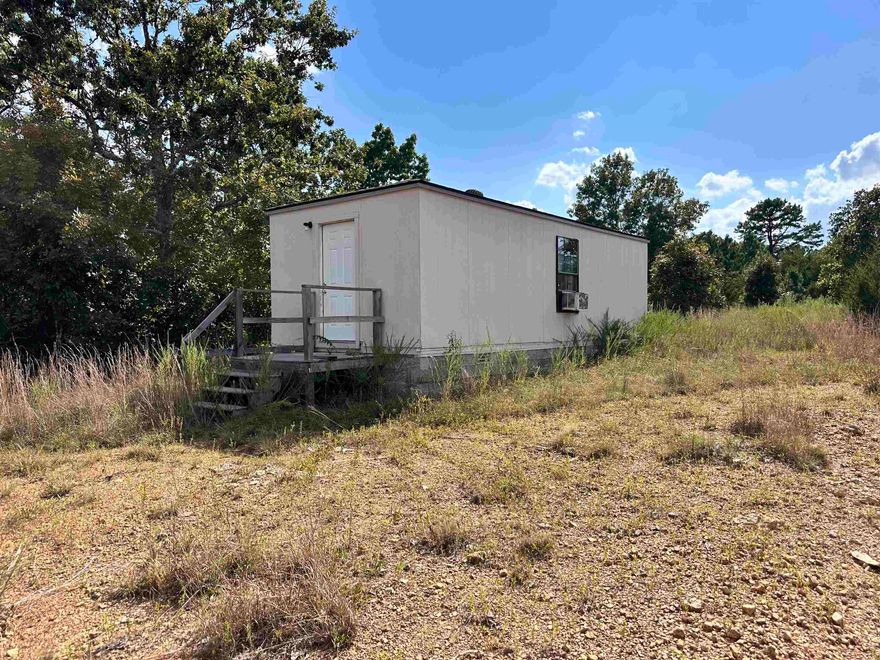 Escape to the serenity of the countryside with this cabin ready for outdoor enthusiasts. Nestled on 8 level acres teeming with wildlife—including deer and gobbling turkeys—this property offers the perfect blend of adventure and tranquility. Property Highlights: Cabin with electricity and a bathroom, Peaceful pond ideal for relaxing or attracting game, Private well on site, Usable land—great for hunting, or future development. No septic system currently installed.  Whether you're looking for a weekend getaway, a hunting basecamp, or a quiet slice of nature to call your own, this property delivers. Bring your gear, your imagination, and your love of the outdoors.