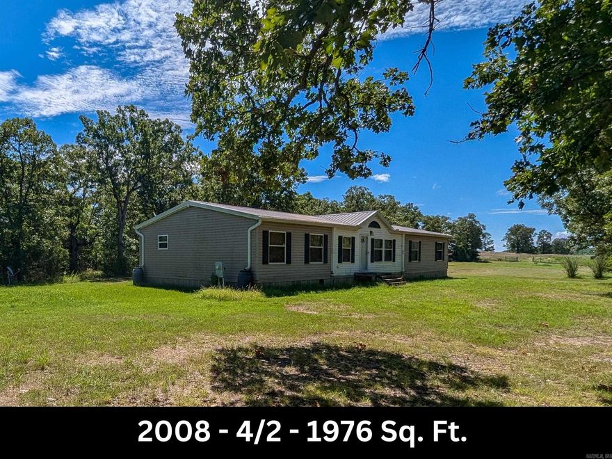 This property is a diamond in the rough! In the early years part of this property served as a private landing strip. Today, this property serves as home to 2 double wide mobile homes & is minutes from Lake Norfork! The newer double wide (2008) provides plenty of living space with 2001 +/- sq. ft. (see plan in Assoc. Docs) with an open floor plan that includes a living room, a dining room and den combo with fireplace, spacious kitchen with island, 4 bedrooms & 2 baths. The primary suite and ensuite bath features a soaker tub plus shower. Updates in the past 8 years include a new roof and HVAC. Also included is a fixer-upper 3 bedroom & 2 bath, 1993 double wide with 1920 +/- sq. ft. that is permanently attached. There is a massive deck to enjoy the views of the rolling acreage. There is also a 40x60 barn with electricity and lean-tos on each side and an additional 10x16 storage building. Includes a well (updated within last 5 years) which services the property. Property also includes a 10x16 Storage shed. If you are an avid hunter and want to take it to the next level, this land has plenty of deer and turkey for you! Remember Don't Buy Or Sell Alone! LEGAL DESCRIPTION IN ASSOC DOCS.