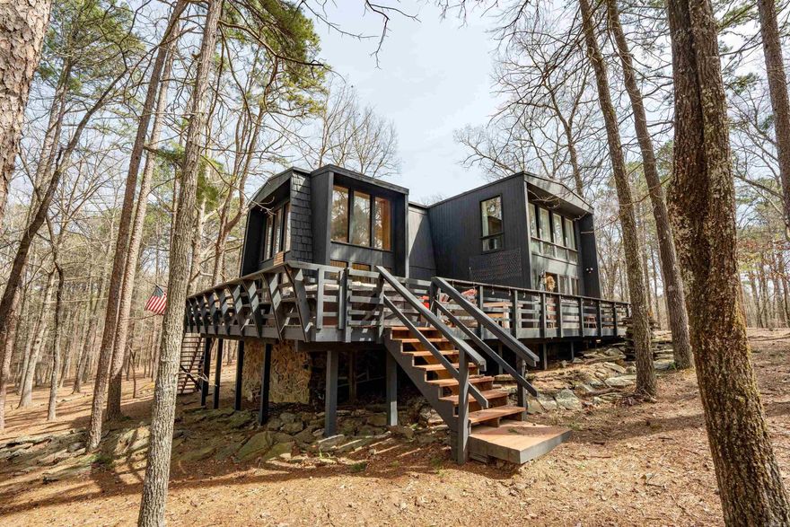 Tannenbaum Lake Fun!!!  This wonderful, almost completely furnished lake house on 3 lots (lots have been replatted into one large lot), has everything you'll need...3 bedrooms and 3 full baths, large living area with 2-story wall of glass and new LVP flooring, large wraparound deck, awesome stone fireplace, breakfast bar, stainless appliances, Andersen windows, large panty, single car garage for lake toys, LOTS of privacy, all just a short golf cart ride to the lake or Tannenbaum Golf Course!  Balcony off of one upstairs bedroom, nice living area in the other upstairs bedroom.  New exterior paint in 2024, new LVP flooring...this place is ready to enjoy!!!