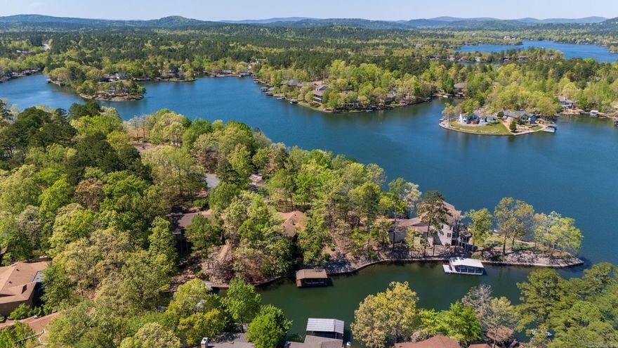 This 4-bedroom, 3-bath beauty is tucked into a deep-water cove with everything you need for full-time living or weekend escapes. Two spacious decks—upper and lower—offer lake views and seamless indoor-outdoor flow. Entertain with ease, then take the paved golf cart path to your covered boat dock (with lift) for a sunset cruise. Inside, you’ll find generous living spaces, open floor plan, a cozy fireplace, and tons of storage throughout. The coveted 3-car garage is a rare find on the lake, perfect for all your toys, don’t miss the lower-level workshop! Whether you’re hosting the crew or enjoying quiet mornings by the water, this home is built for lake life! Lakefront Living on Lake Balboa!