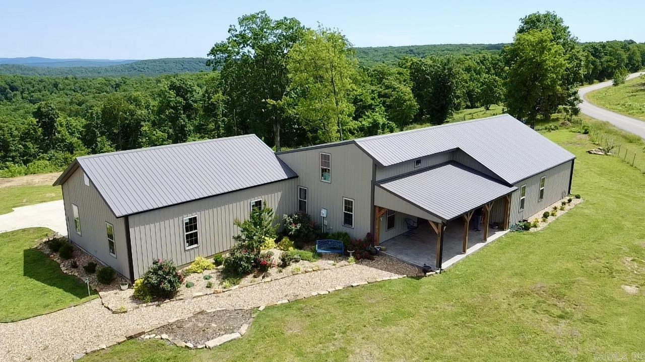 Nature Loverās Dream! Rustic Mountain Home on 10 Acres Bordering the Ozark National Forest. Just 20 minutes from town, this 2,950 sq.ft. mountain retreat offers modern comfort in a stunning natural settingācomplete with trails, waterfalls, & caves nearby & a pond plus wet-weather stream on site. Featuring 4 beds, 3 baths, a sunroom with mountain views, wood accents throughout, and a massive upstairs bedroom with built-ins, the home blends rustic charm with thoughtful design. Extras include a 3-car garage, two fireplaces, bonus room, office, and mini-farm setup with fencing, kennel, and coop. High-speed internet, paved access, and public water make this private paradise truly move-in ready. Can be purchased with additional land and 40 x 60 metal shop.