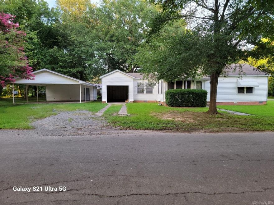 Move-in Ready! This charming, newly restored, 1156 square foot, two bedroom, and one bathroom house, nestled on a pretty corner lot, would make a perfect starter home for a single person, a couple, or small family. You must read all the features listed on simsrealty.com to really appreciate it.  Here's what this property has to offer:  A new electric stovetop, all appliances stay including a washer & dryer, double pane windows, full bathroom in the hall with tub/shower, huge parking shed with large storage room, Large shaded, chain-link fenced back yard, most of the floors are vinyl planks, the rest are vinyl, new flooring throughout, new water heater, small front porch & patio, two storage rooms at the back of the single open garage, that also open to the back yard.