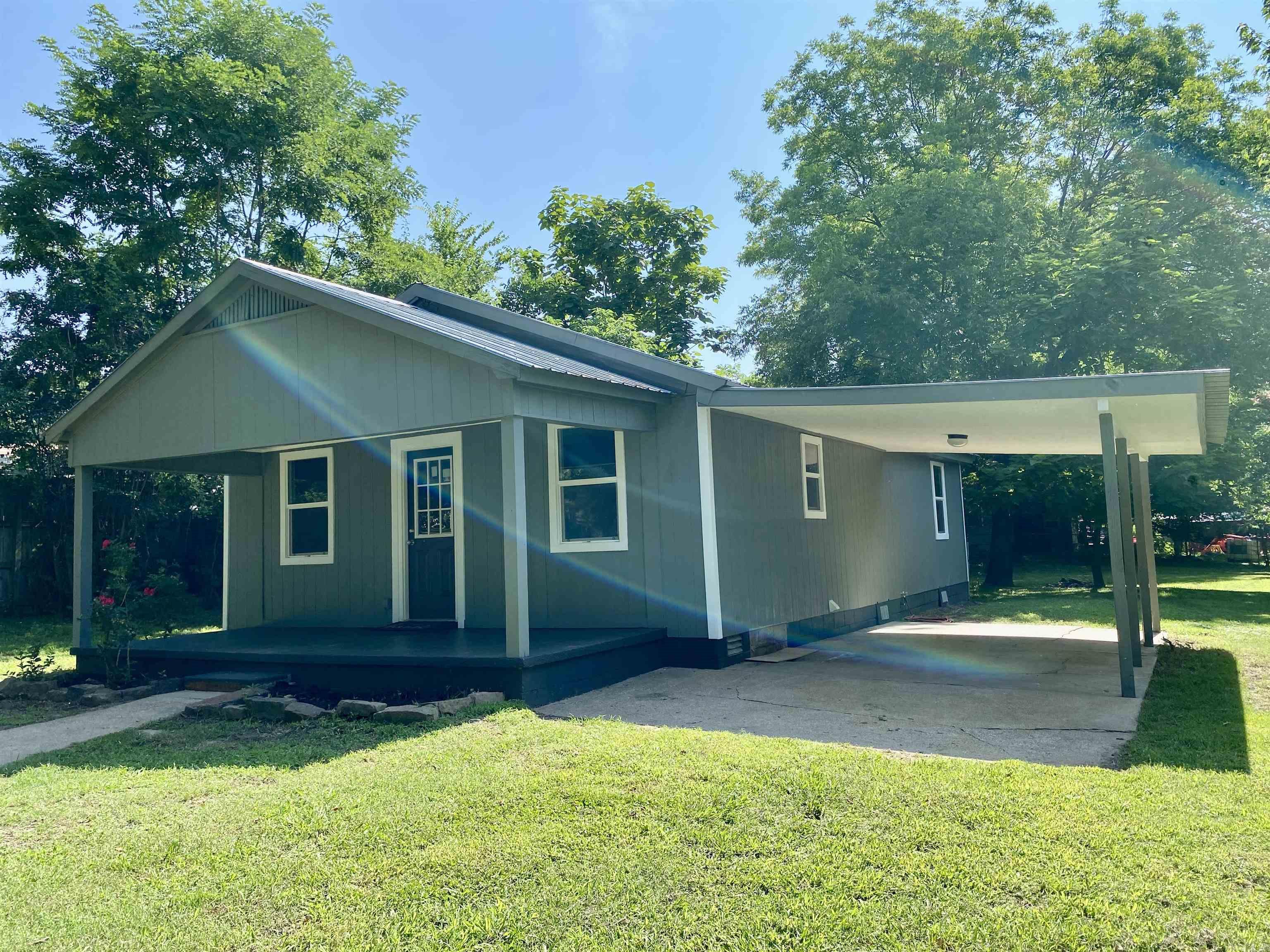 This completely remodeled bungalow sits on a partially fenced lot with room to garden and relax. Step onto the inviting covered front porch or enjoy the oversized carport perfect for outdoor gatherings or extra patio space. Inside you will find new flooring, fresh paint & updated fixtures with all new systems including HVAC, water heater, electrical and plumbing for Peace of Mind. The galley kitchen hosts new cabinetry & range with a dedicated laundry area nearby. The primary suite offers double closets for ample storage. Located just minutes from the Arkansas and only 2 blocks from the City Park, this home blends Comfort and convenience. Eligible for all loans including the $0 down USDA RD Program.