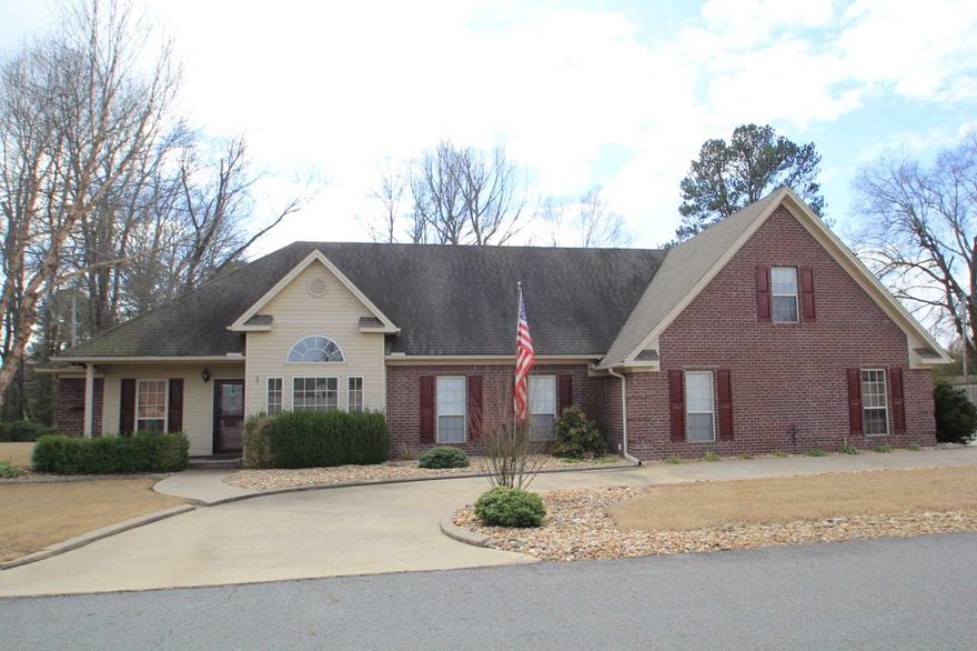 Immaculately maintained spacious home on large corner lot. Convenient circle drive.  Large patio to enjoy outdoor entertaining. All of main living spaces downstairs, but an almost 500 sq ft bonus room upstairs could serve as 4th bedroom, game room, media room, etc.  Beautiful kitchen with lots of cabinets and movable island. Refrig stays! Spacious master suite with gorgeous acacia wood floors. Guest suite can be closed off for privacy.  Septic tank connects to community sewer system.