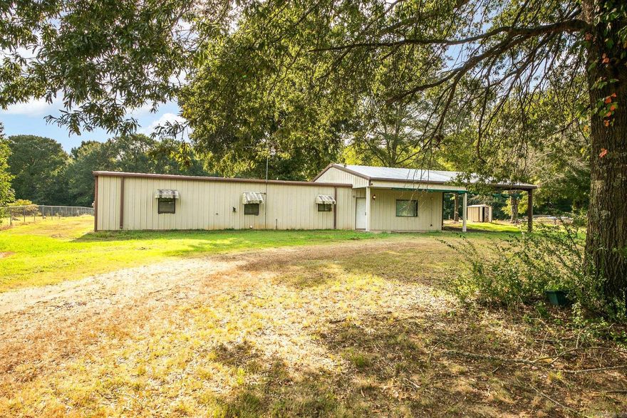 Awesome 7.5 Acres with trees and partially fenced, shop with living quarters that is 1500 sq ft, 2BR 2BA with shop door on the back. Covered parking on one end, Storm shelter and plenty of space to build or add on. This property backs up to Mingo Creek Hunting Club.