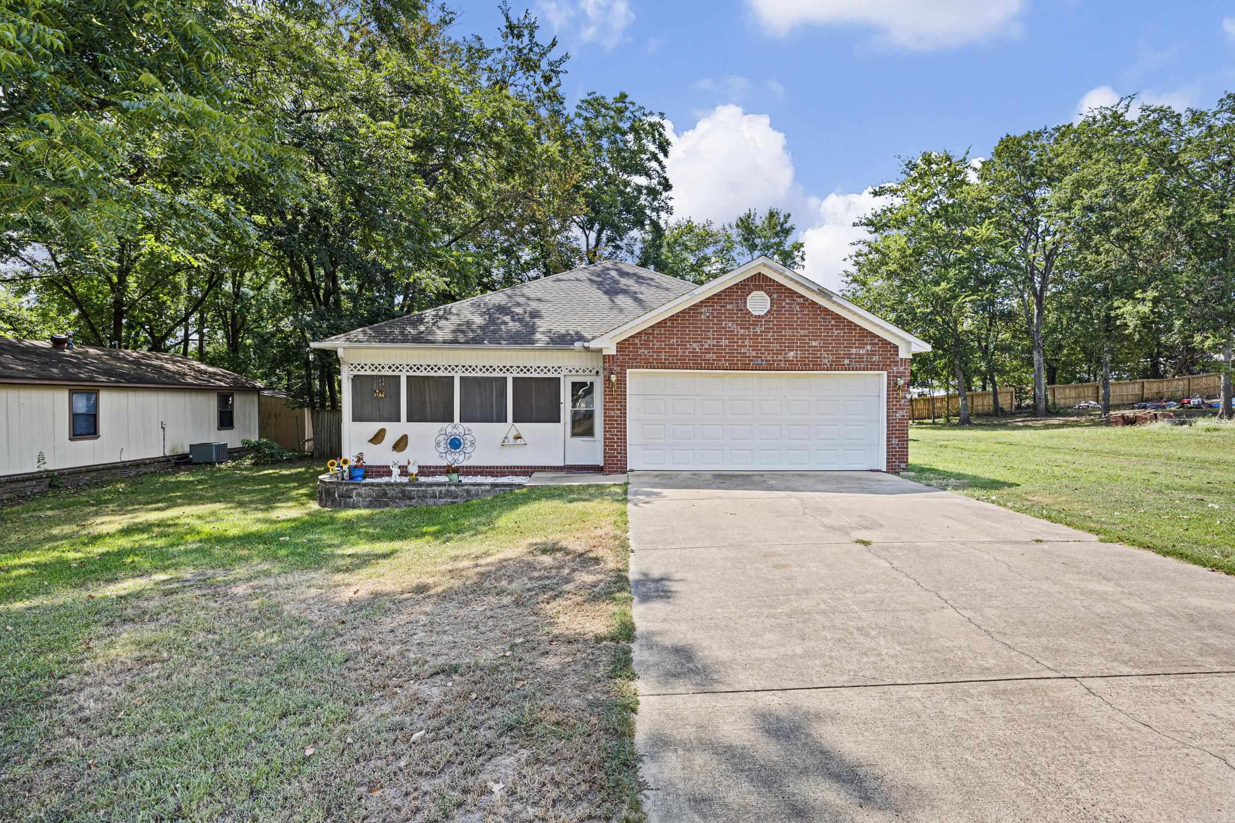 Discover this 3-bedroom, 2-bath home built in 2007, offering 1,388 sq. ft. of comfort and style. Nestled on approximately 1 acre in the beautiful small town of Morrilton, it boasts an enclosed front porch, perfect for morning coffee, and a fully privacy-fenced backyard for outdoor enjoyment. Inside, luxury vinyl plank flooring flows throughout, combining elegance with easy maintenance. Enjoy the convenience of being close to everything while savoring the tranquility of a spacious lot. This home is move-in ready and waiting for you to make it your own!