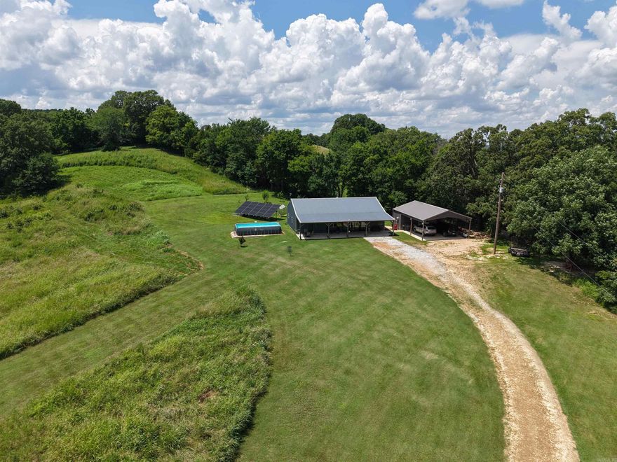 Escape to the Ozark Mountains with this modern 2-bedroom, 2-bathroom barndominium situated on 9 picturesque acres.  This rural property is designed for energy efficiency, featuring solar panels that offer minimal to no utility bills—perfect for sustainable country living.  Inside, you'll find a warm farmhouse feel, while outside, a covered front porch invites you to take in the stunning mountain views. A detached carport with an attached workshop area provides space for projects, storage, or outdoor gear. Surrounded by abundant wildlife, this property  also makes a fantastic hunting and recreational getaway.  Located less than 5 minutes from the famous White River and conveniently situated between Melbourne, AR and Mountain View, AR, this Ozark gem offers the perfect mix of peaceful country living and easy access to local amenities.  Whether you’re seeking a weekend retreat or a full-time homestead, this unique Ozark gem offers it all for only $299,900!