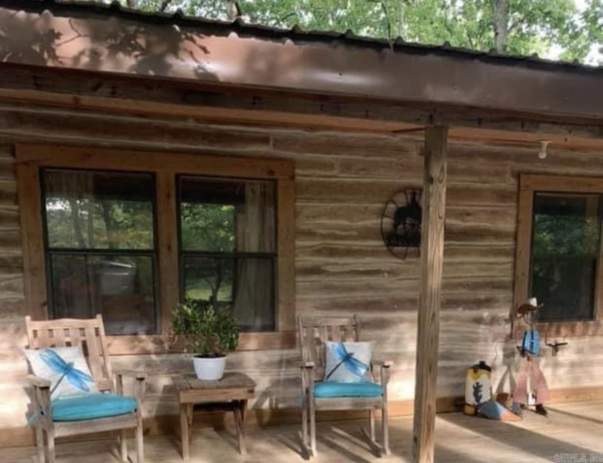 Captivating property with 2 home sitting 17 picturesque acres 1 mile from Scenic Buffalo River & Historic Town of Gilbert. One cabin is 1500 Sq. Ft., 3 bed, 2 bath other 540 Sq. Ft., 1 bed, 1 bath. Larger home features, custom dry stack fireplace, screened-in back porch, large country wrap around porch, both have open floor plans. Fenced & cross fenced, barn with additional outside covered stalls. Small pond & year round spring. Both homes are currently on VRBO, AIR BNB, facebook, can continue renting both or live in one and use the other for income. Must see!