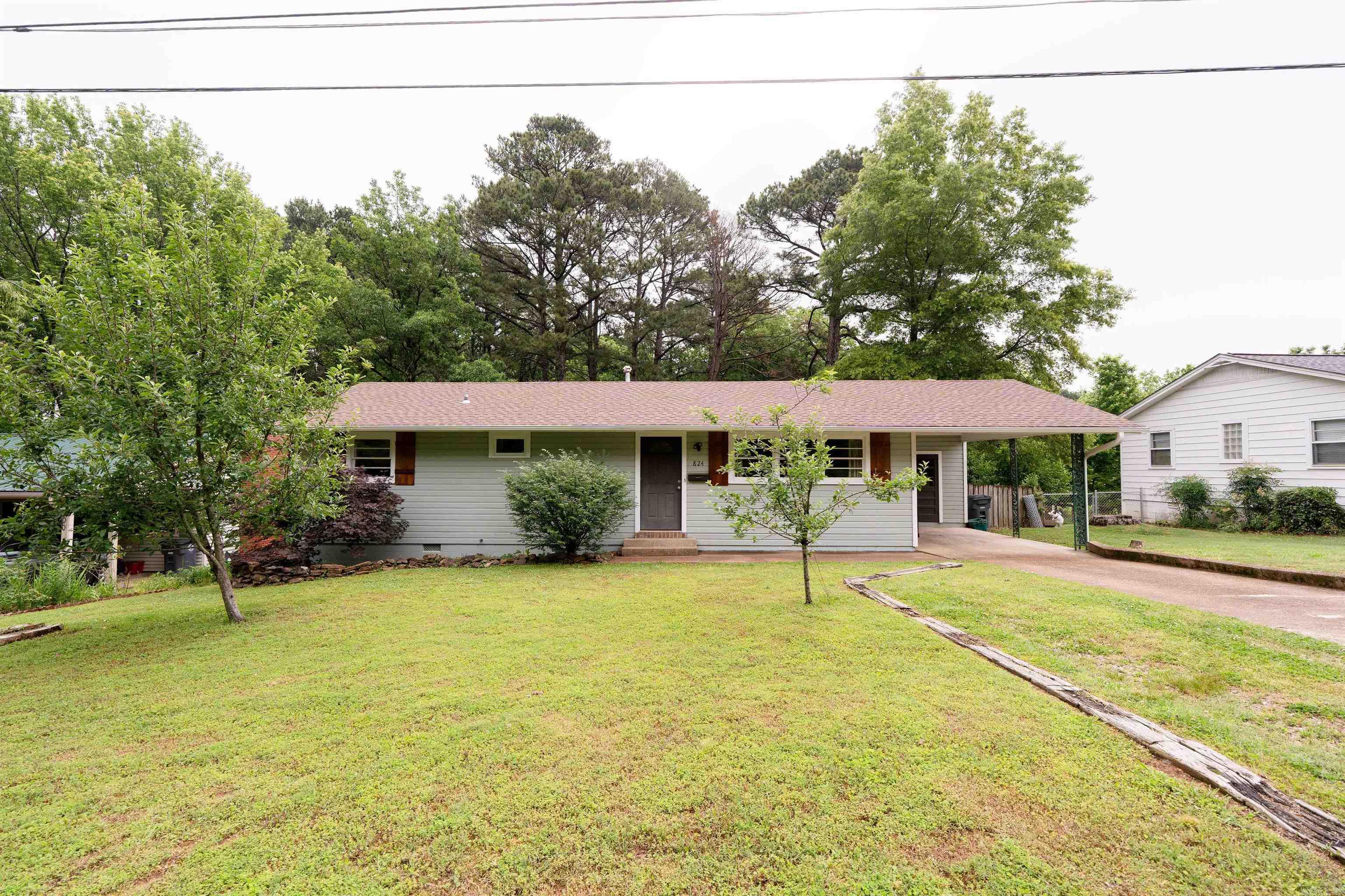 Charming 1958 Home w/Modern Updates & Timeless Appeal.Step into this beautifully maintained 3-bedroom, 2-bathroom home that perfectly blends classic character w/thoughtful updates. Featuring a desirable split floor plan and two spacious living areas, this home offers flexibility & comfort for everyday living & entertaining. Plenty of space for a dining area and convenient breakfast bar provide plenty of room for gatherings. The main bathroom boasts a double vanity, while the master suite includes walk-in shower. Throughout the home, you’ll find a mix of original hardwood floors & stylish new LVP flooring, enhancing both warmth & durability. Enjoy an abundance of storage with oversized closets, a storage room under the carport, and a full-size UNFINISHED basement (ext. entrance) complete w/workspace & room for lawn equipment. There’s even a storm shelter under the home for added peace of mind. Outside, the freshly repainted exterior charms, & a large deck overlooks the expansive backyard, perfect for relaxing or entertaining. Fruit trees including apple, peach & elderberry—add sweet touch of nature. With a newer roof, and charming updates that preserve its 1950's soul. Rare Find.