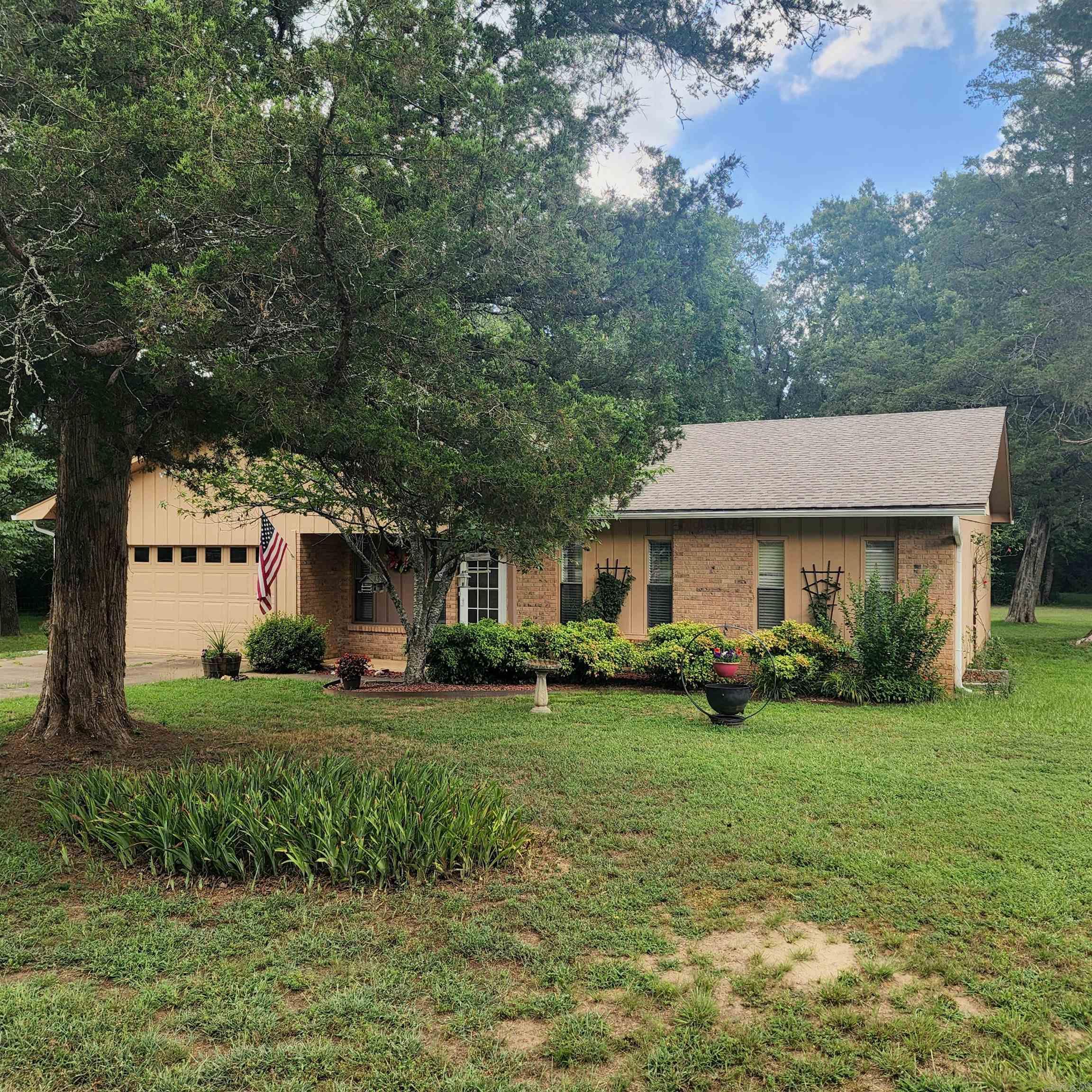 This charming 3-bedroom, 2-bathroom MOVE IN READY home nestled on 1.38 acres in a quiet rural subdivision, located in the desirable Greenbrier School District, offers comfort & country living. The living room & cozy den, featuring a wood-burning insert fireplace, provide ample space for unwinding or entertaining. The open kitchen & dining combo, complete with a breakfast bar, is perfect for casual meals & family gatherings. Step outside to the large back deck, where you can enjoy the calm surroundings & wildlife. Additional features of the property include: 2 car garage with small work bench, a large storage shed & a smaller shed for extra storage. Recent upgrades: New roof and gutters (2023), new HVAC system (2024), and an instant hot water system for the kitchen sink, septic tank pumped in 2023, & small generator that will run half of the house. While the property is located in a Special Flood Hazard Area (Zone A), the owners have reported no flooding in the 10 years of ownership & flood insurance is approx $900.00 year. If you're looking for a well-maintained home with a peaceful rural setting, this property is a must-see!