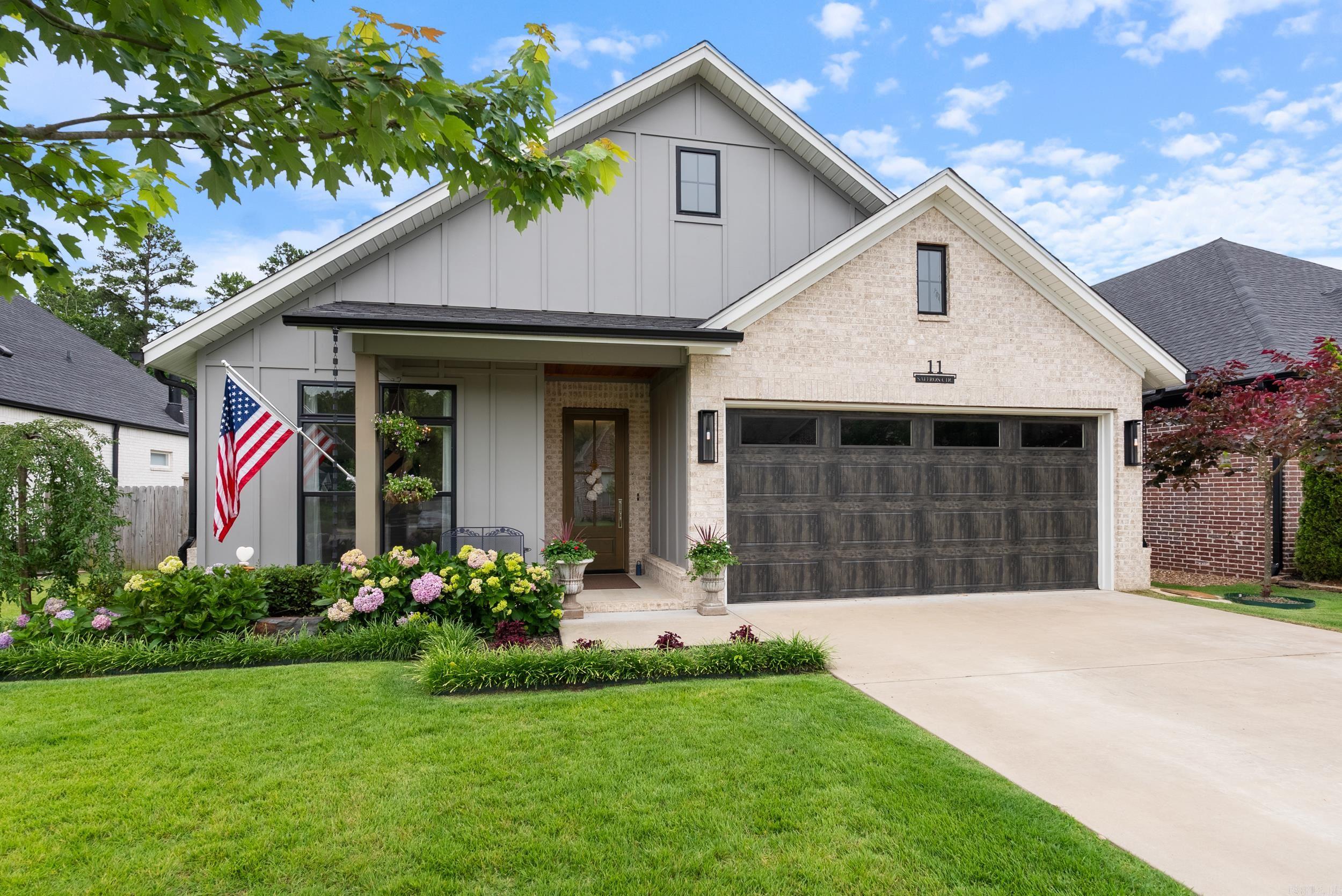 This thoughtfully upgraded home blends modern style with everyday comfort—and it’s packed with features that make it stand out. From the moment you walk in, you’ll notice the upscale feel: solid 8’ doors throughout, statement barn doors, upgraded lighting and plumbing fixtures, and a premium kitchen appliance package. The open-concept great room features soaring 14’ ceilings and floods with natural light, while the seamless connection to the screened-in patio—with its cozy fireplace—creates an inviting indoor-outdoor living experience. The spacious primary suite feels like a retreat, with a spa-inspired bath that includes a jetted tub, large walk-in shower, ample natural light, and generous closet space. Additional upgrades include powered Duette blinds, solid surface flooring (no carpet!), and beautiful finishes from top to bottom. Lawn maintenance is included, giving you more time to enjoy your home without the hassle. Located in a friendly, connected neighborhood and backed up to green space for added privacy—this home truly offers the best of both worlds. Meticulously maintained, smoke-free, pet-free, and gently lived in—affordable luxury is waiting. Come see it for yourself!
